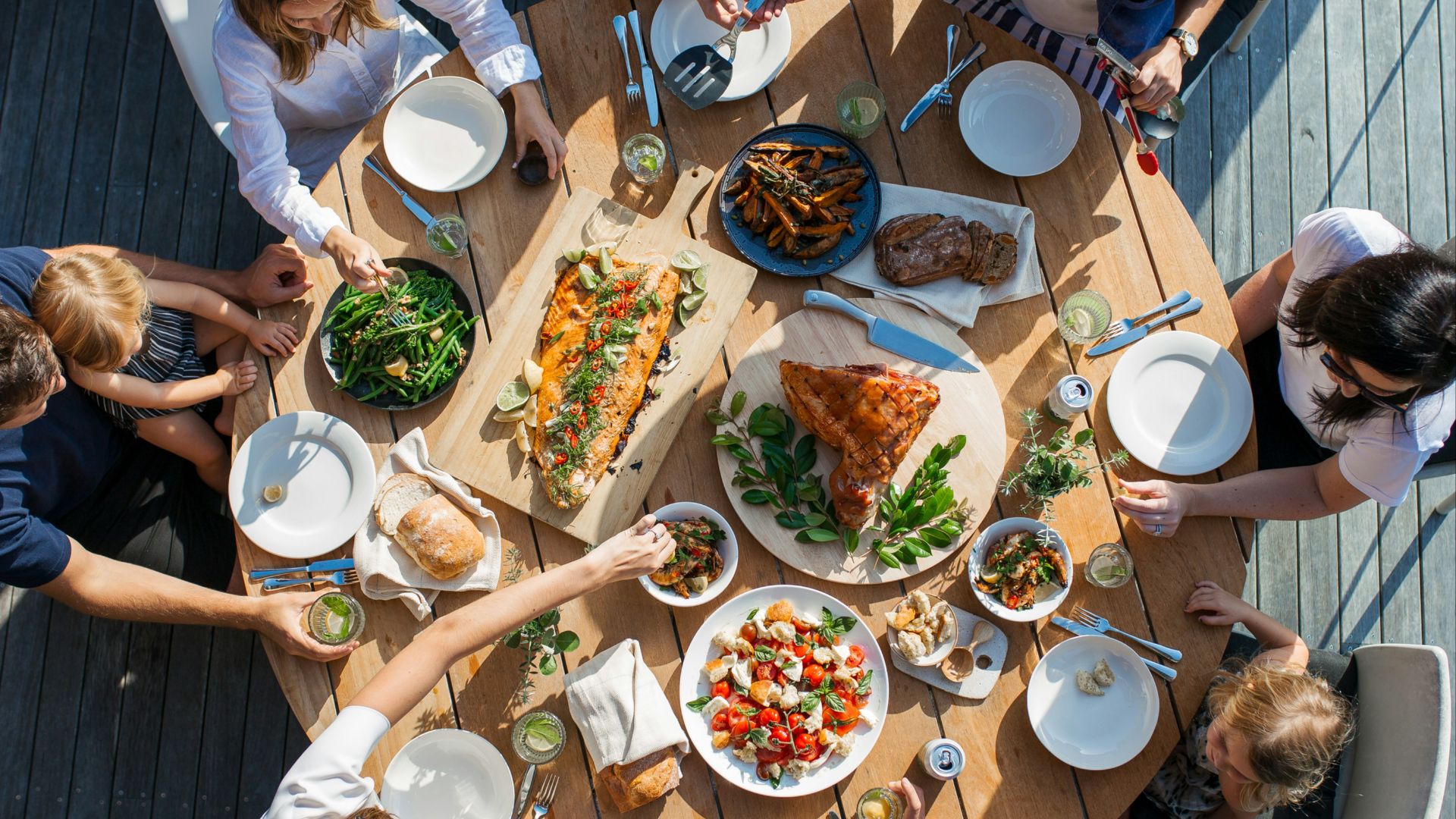 people eating on table with foods