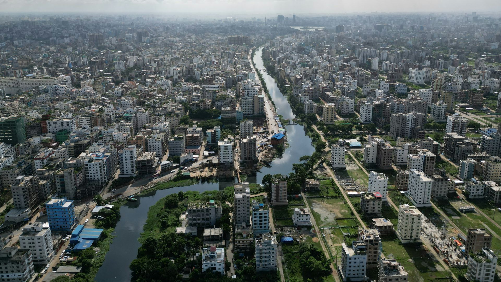 an aerial view of a river running through a city