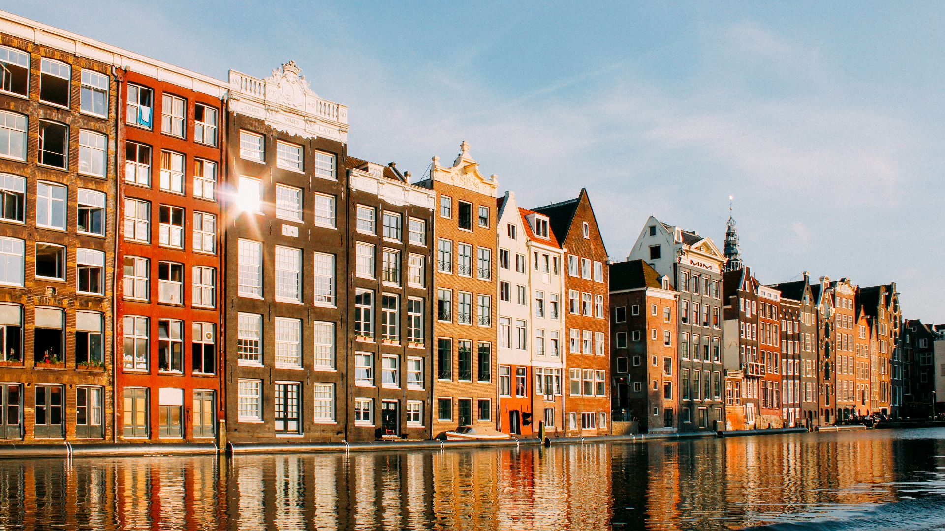 assorted-color buildings beside body of water