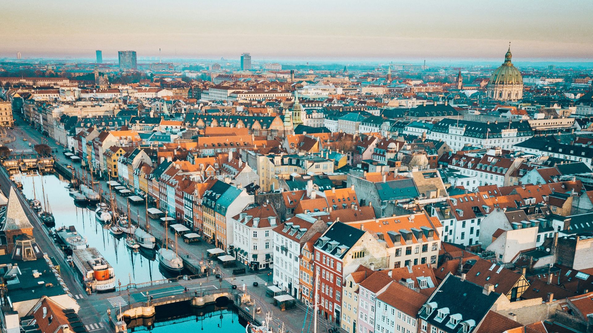 aerial photo of boats in between concrete buildings during daytime