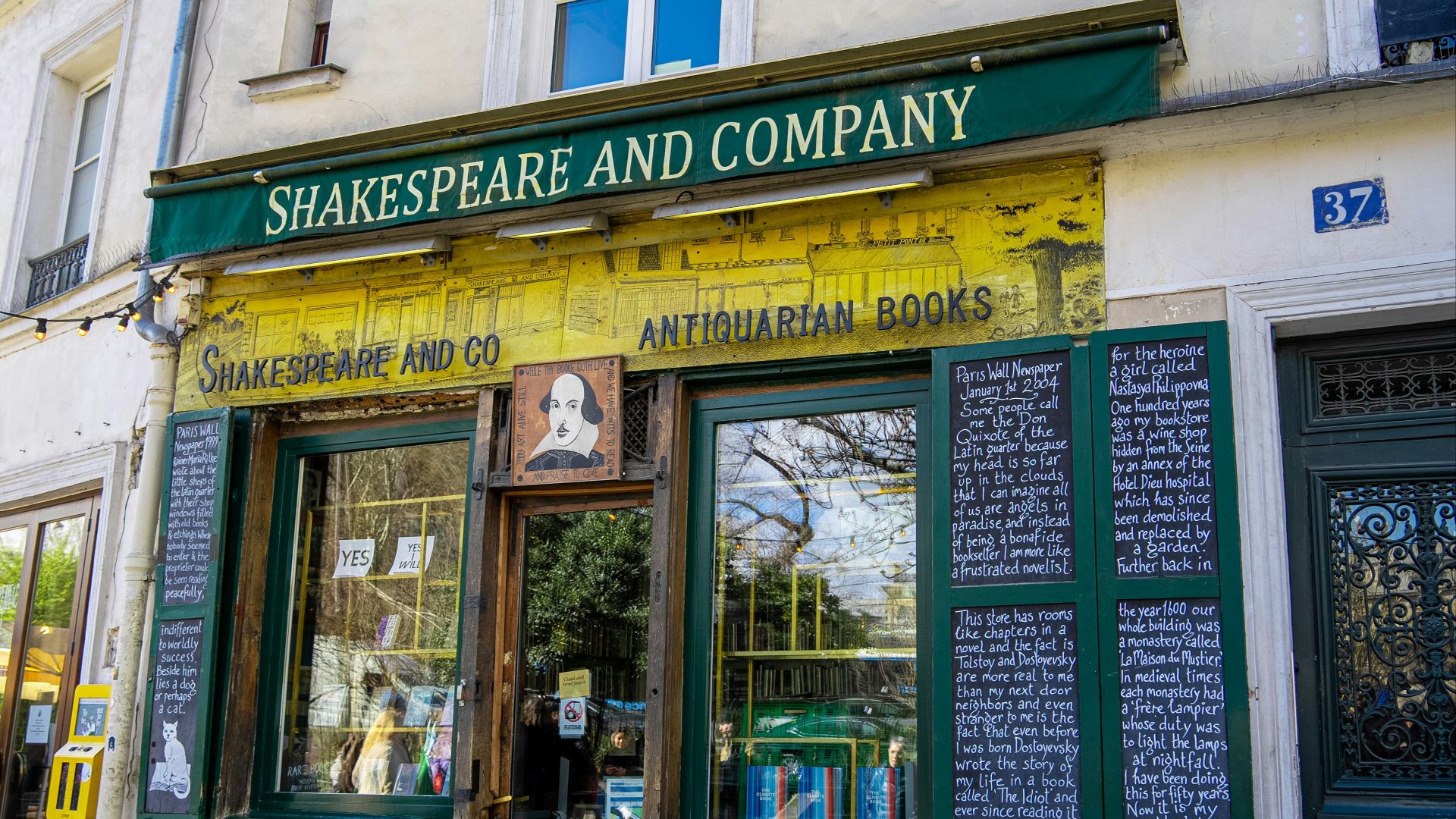 shakespeare and company store front with green and yellow awning