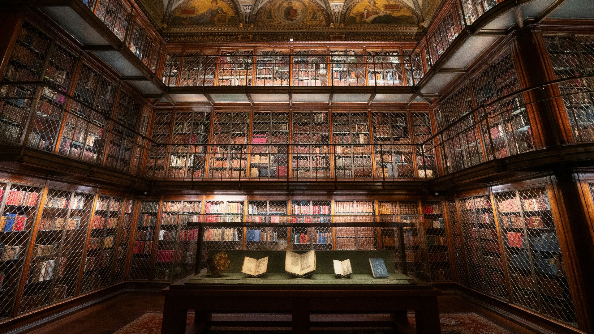An elegant library shows many books on shelves.