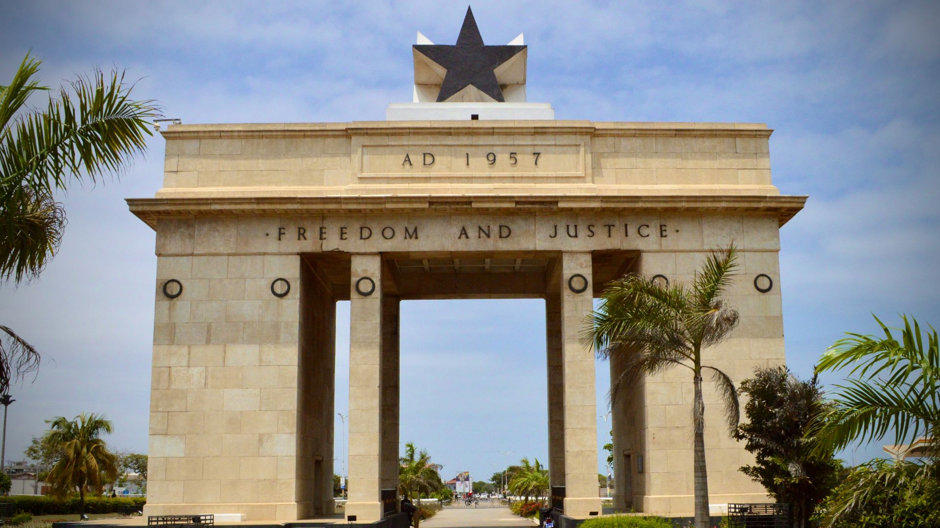 white concrete building with flag on top during daytime