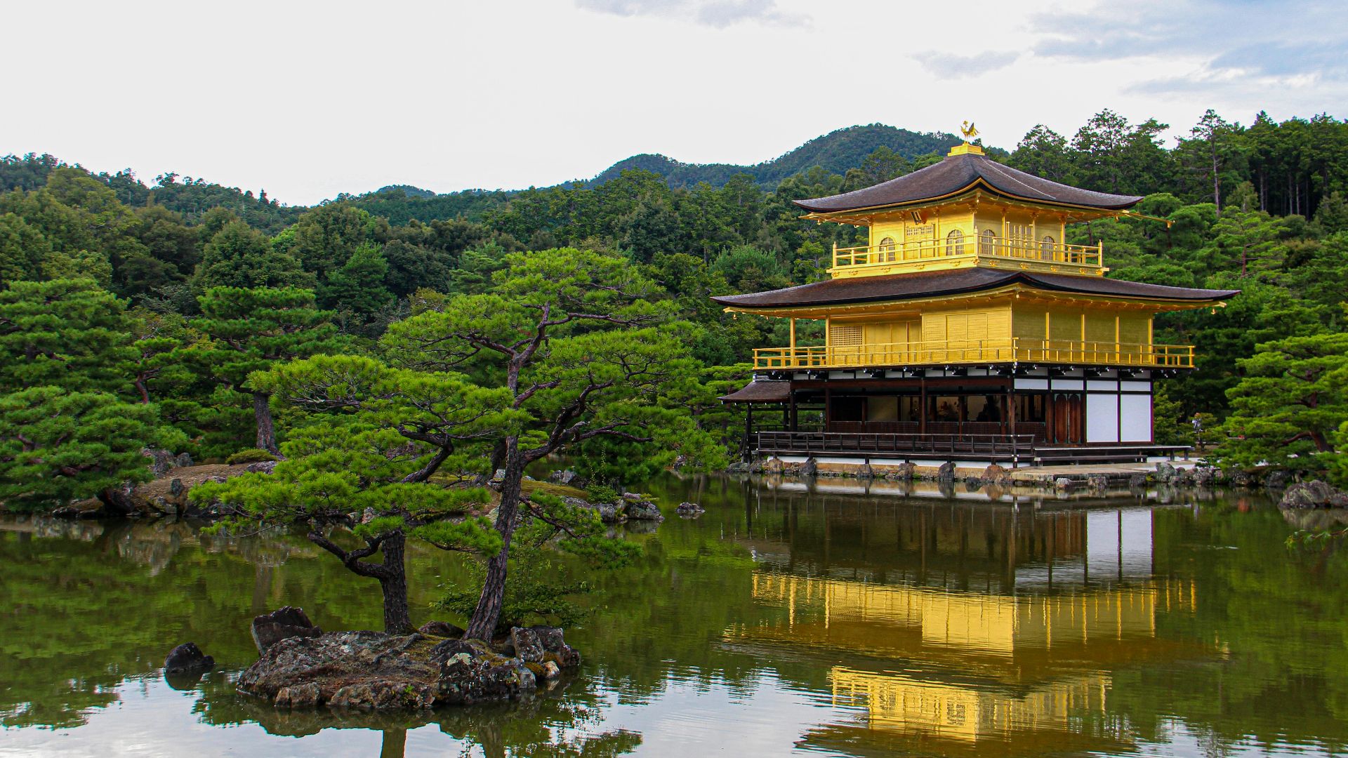 a yellow building sitting in the middle of a lake