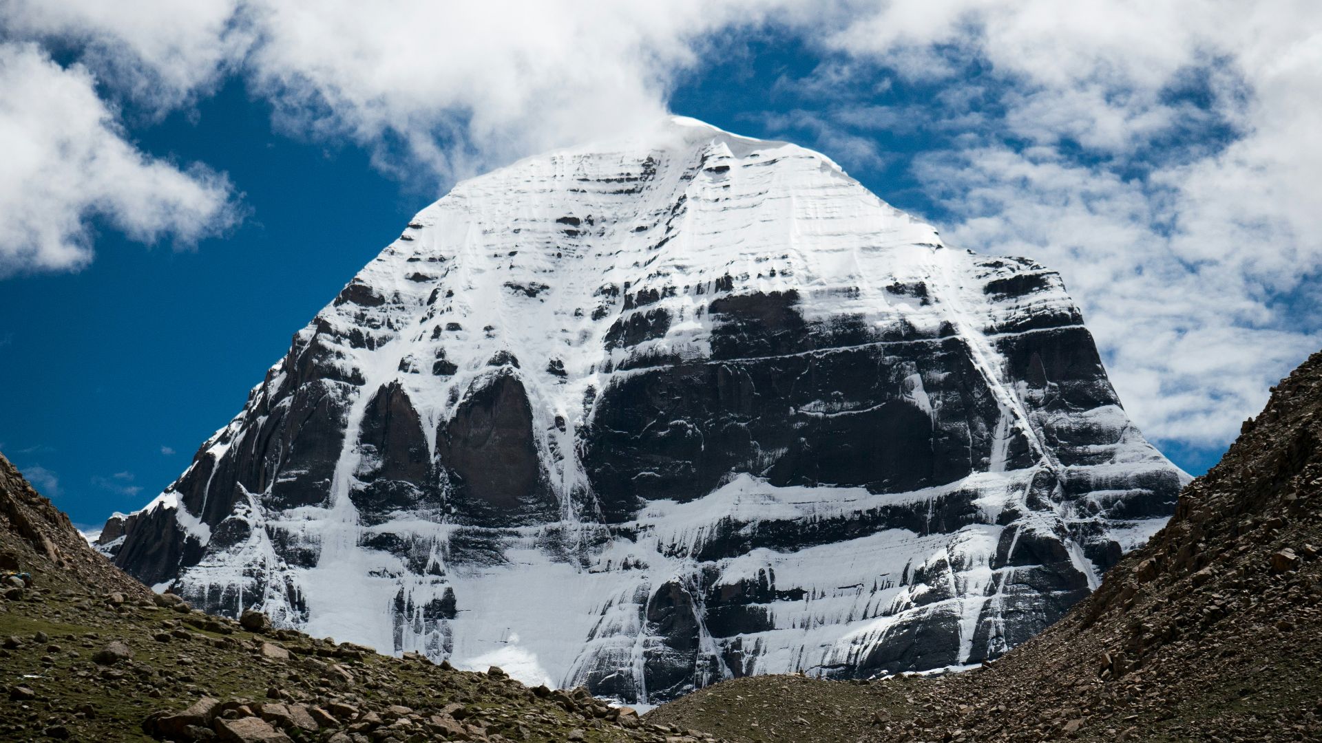 a large snow covered mountain with a sky background