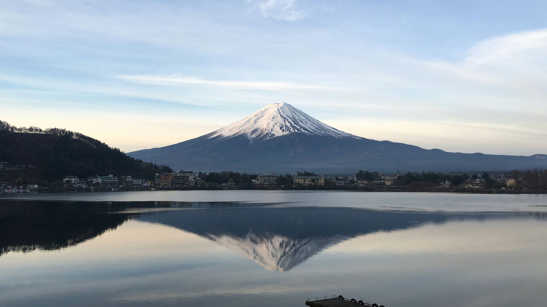 body of water near mountain under blue sky during daytime