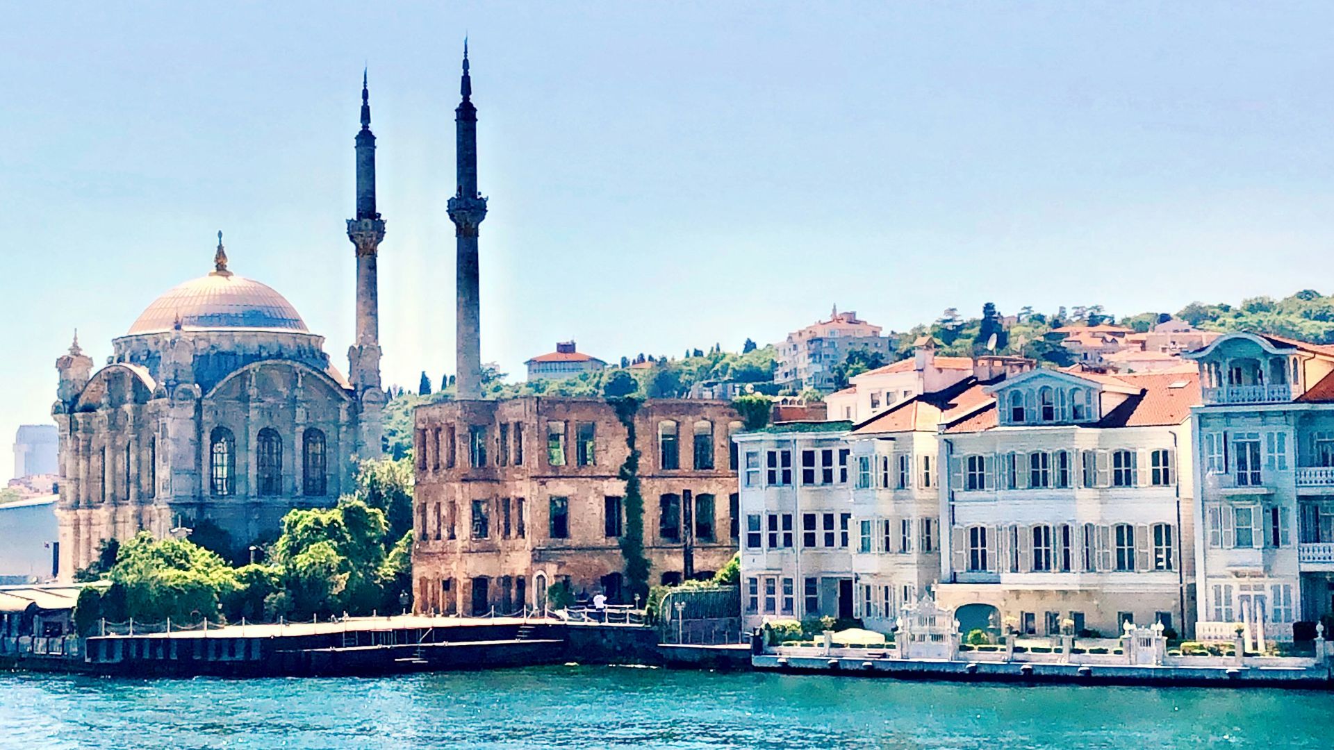 white and brown concrete building near body of water during daytime
