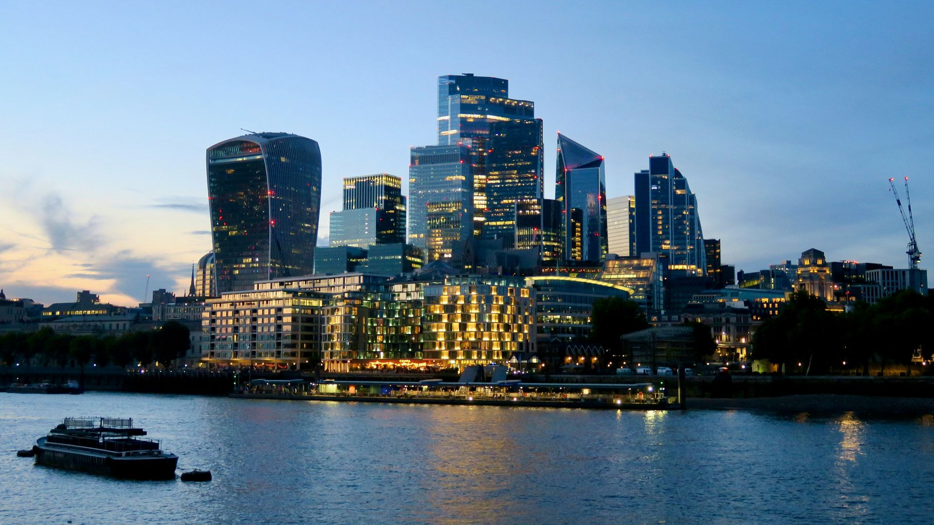 Modern cityscape with illuminated buildings at dusk