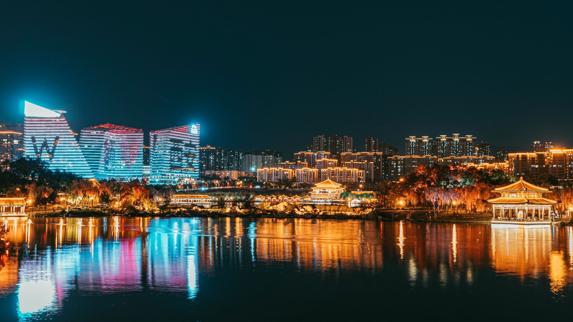 a large body of water with a city in the background