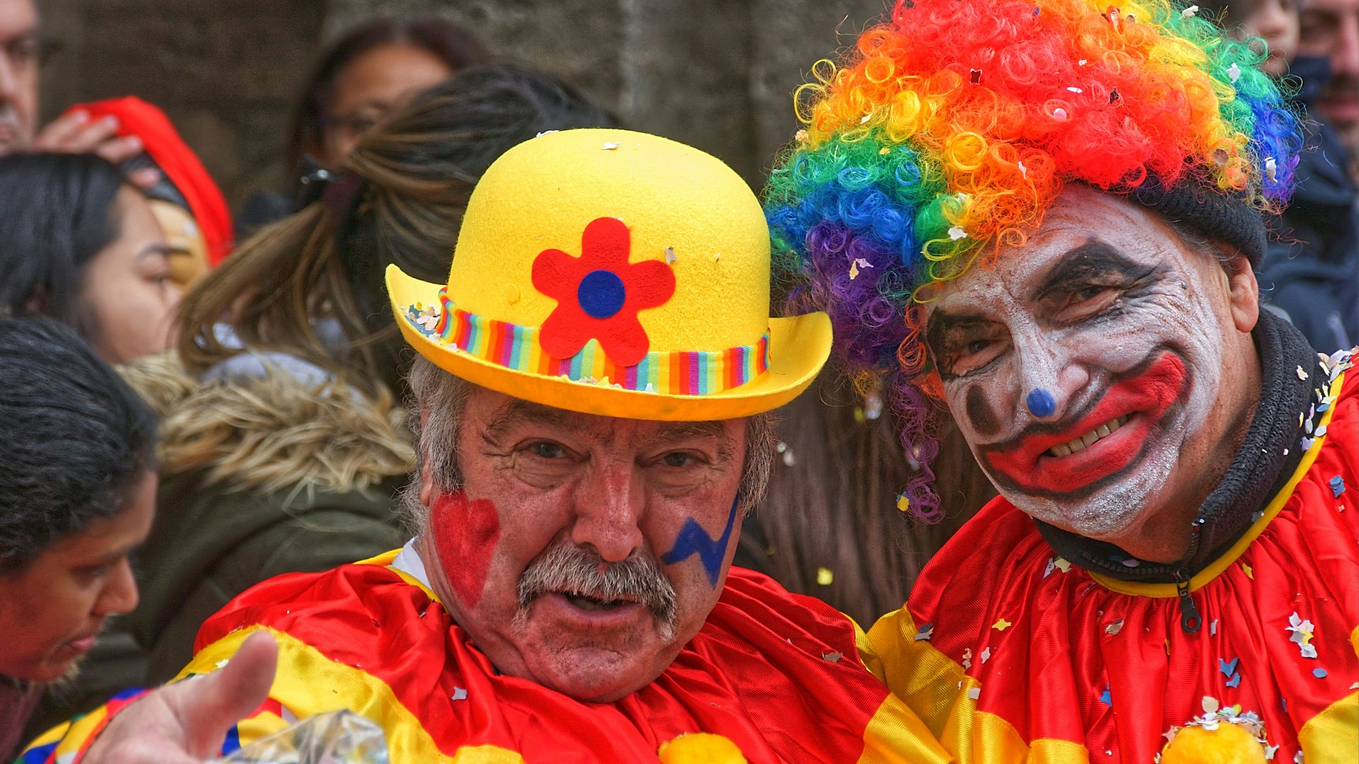 man in yellow orange and blue wig