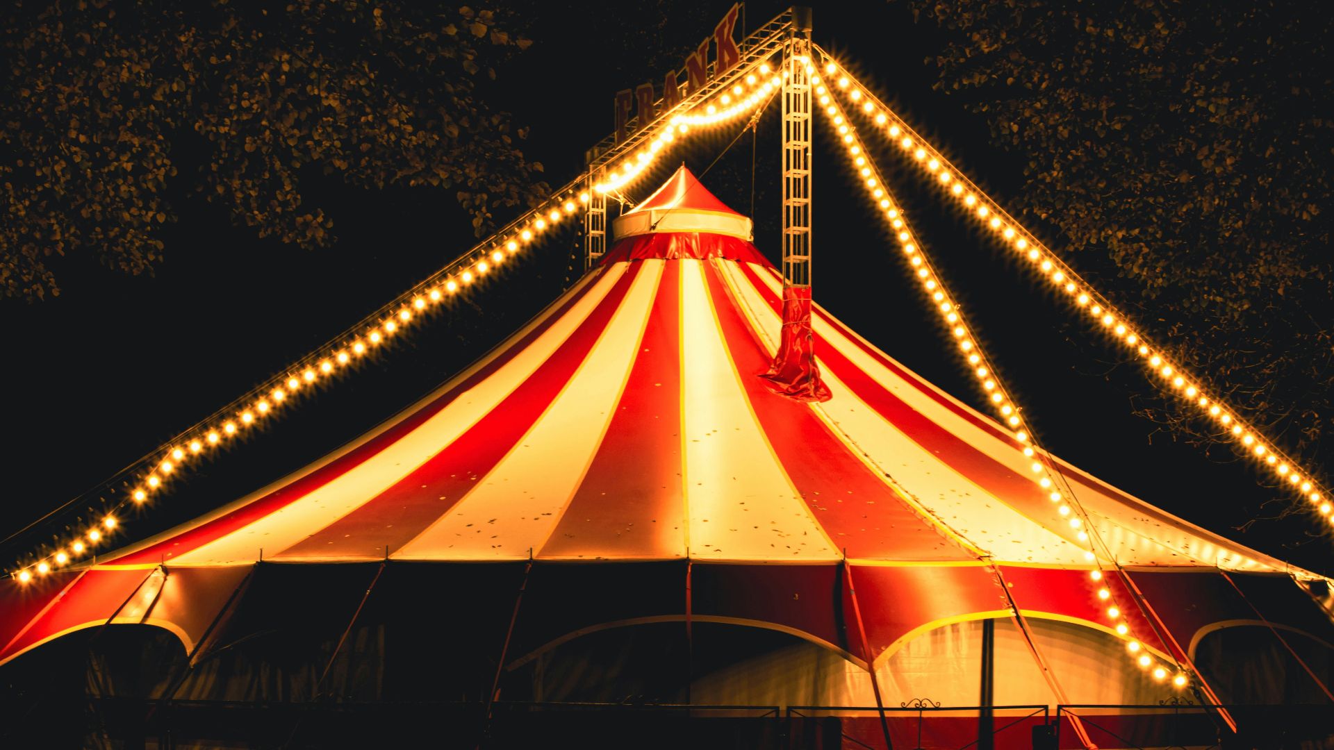 a large circus tent with lights around it
