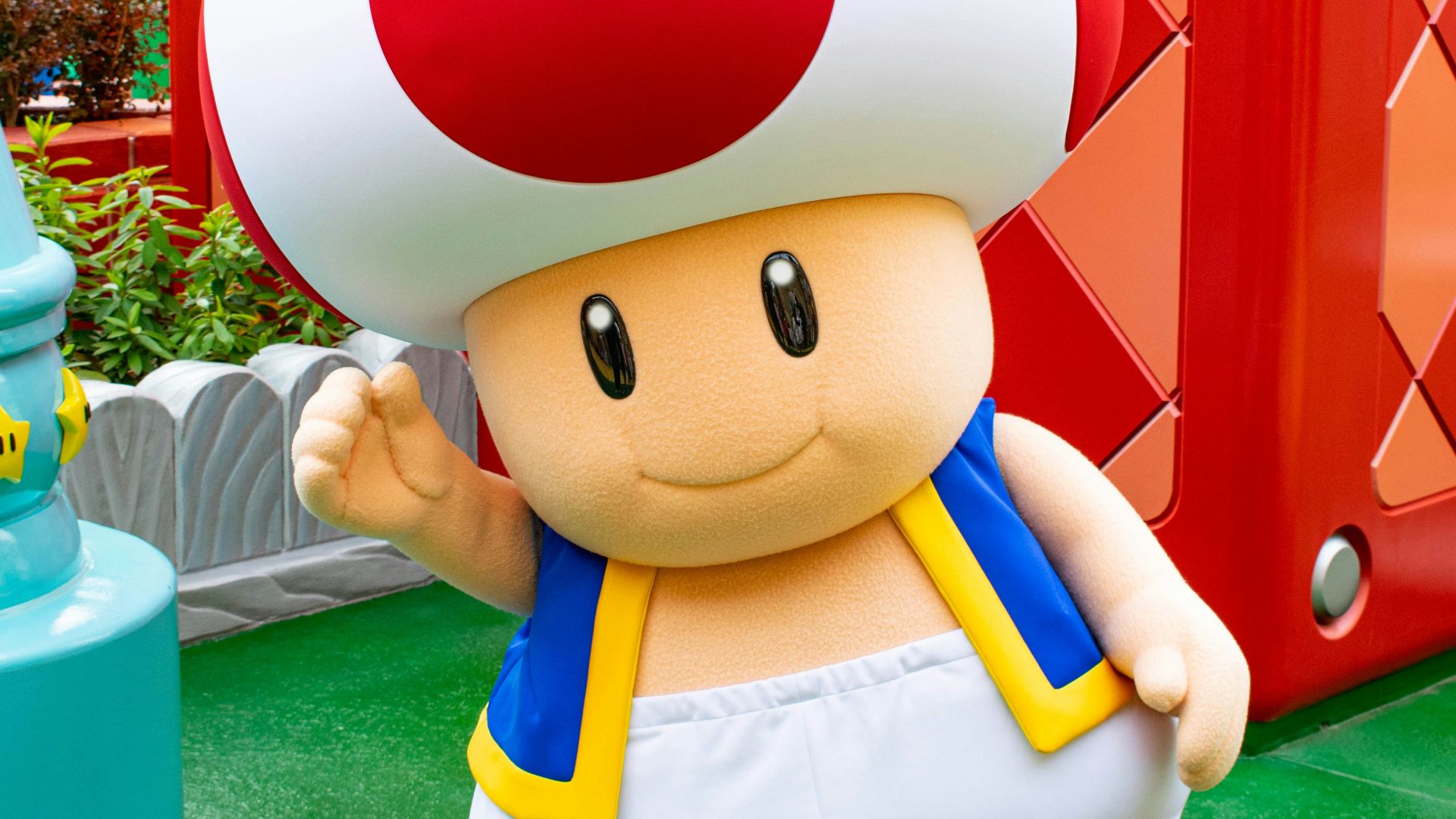 boy in blue and white shirt holding red and white balloon