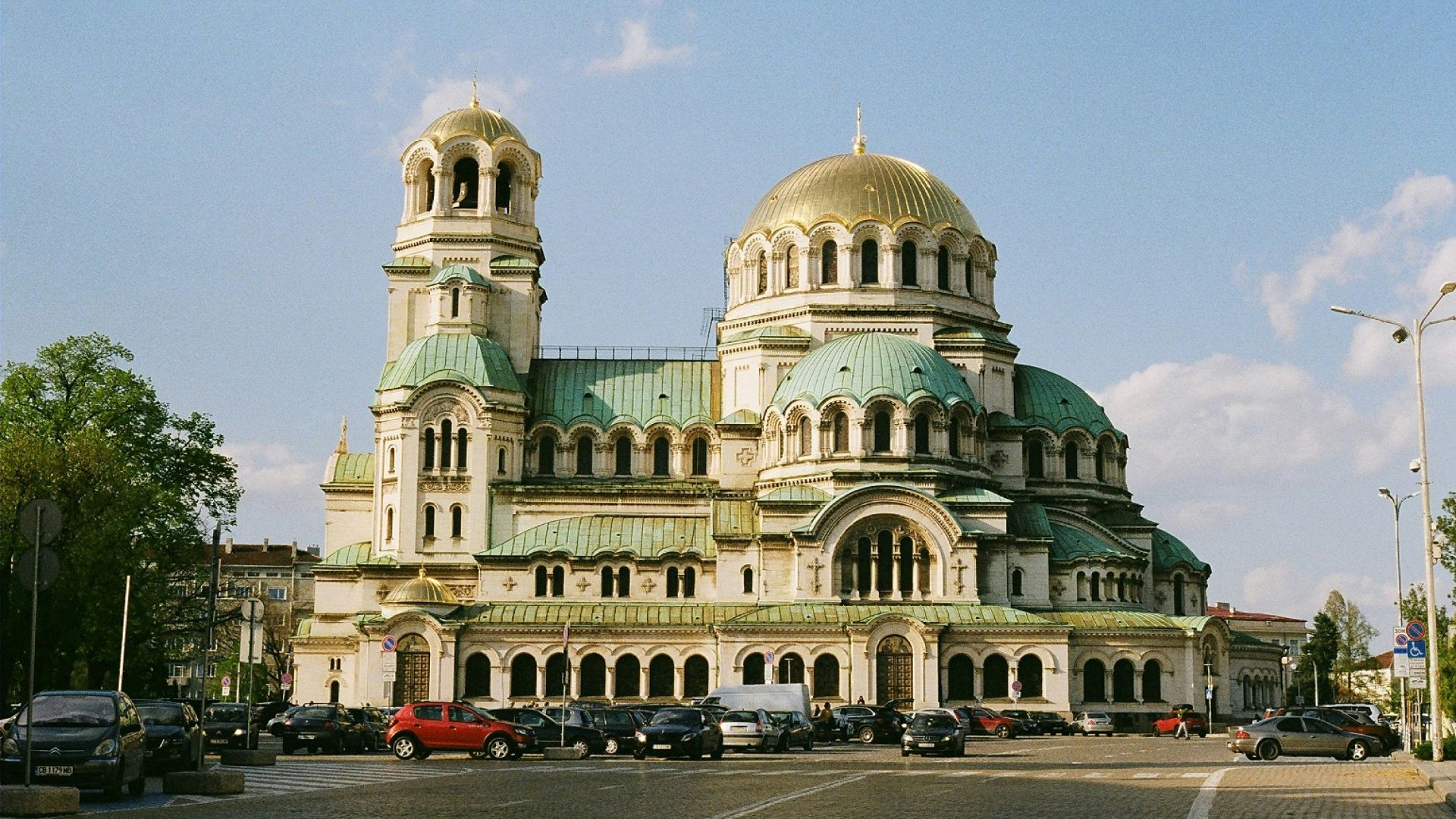 a large white building with a green roof