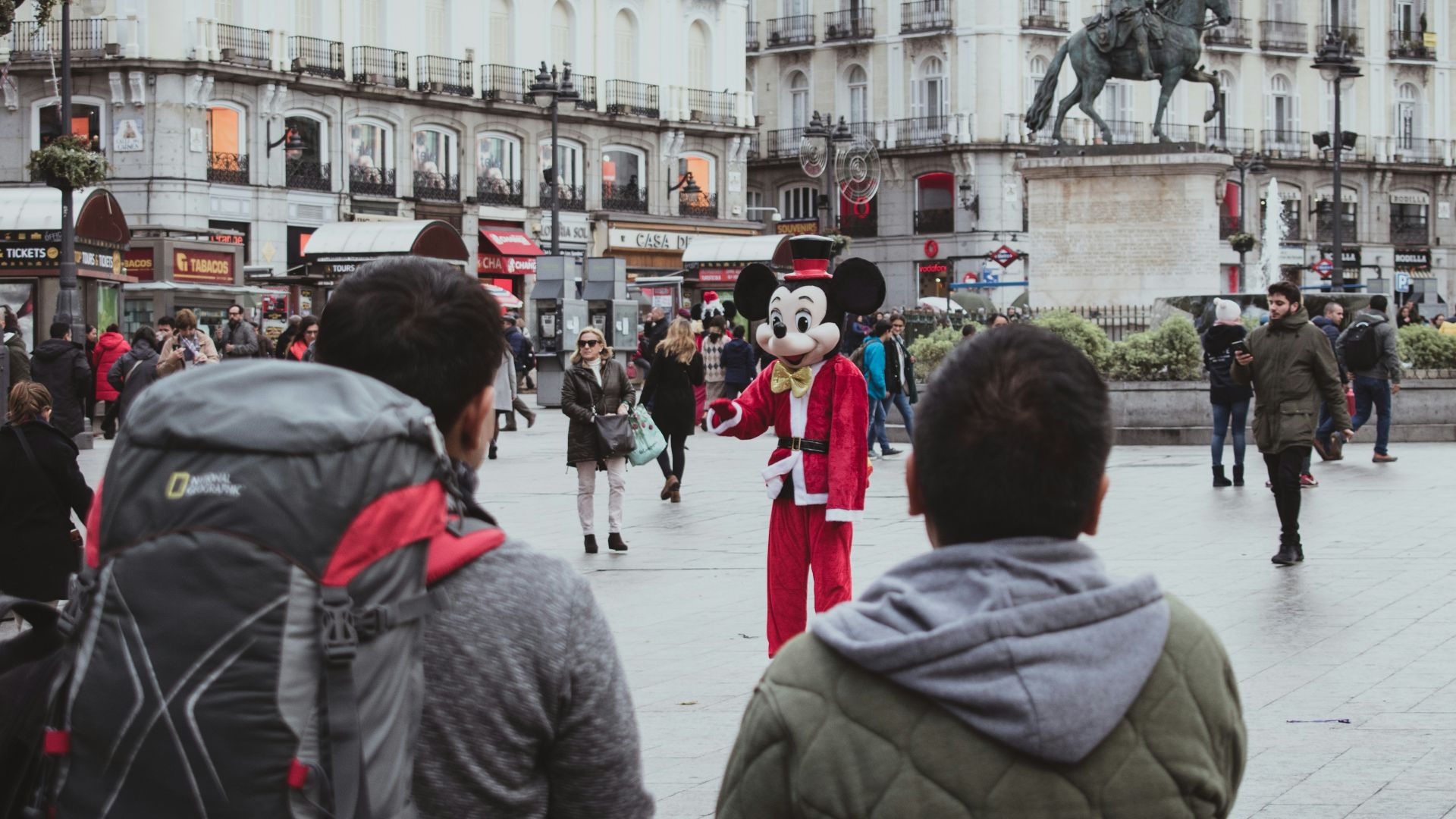 man and woman standing near white concrete building