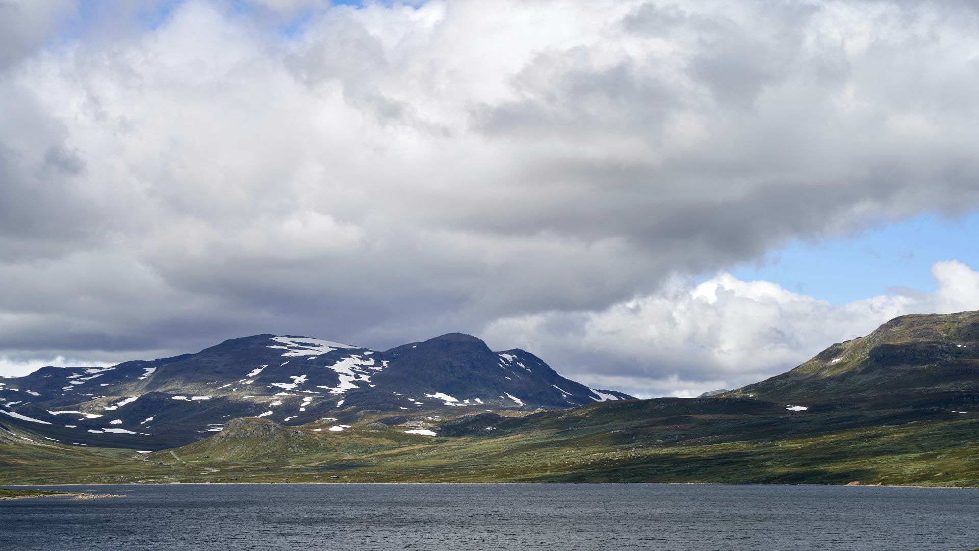 a lake with mountains in the background