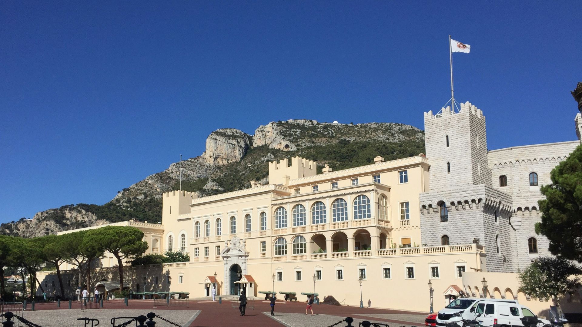 people walking near white concrete building during daytime