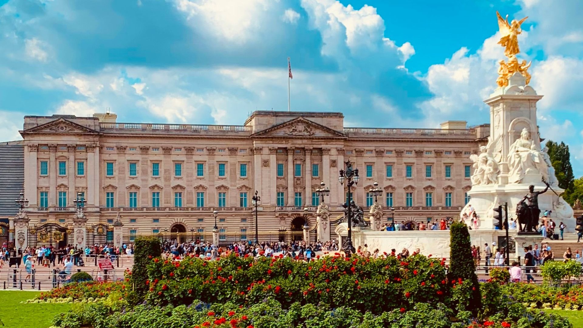 a large building with a statue in the middle of a garden
