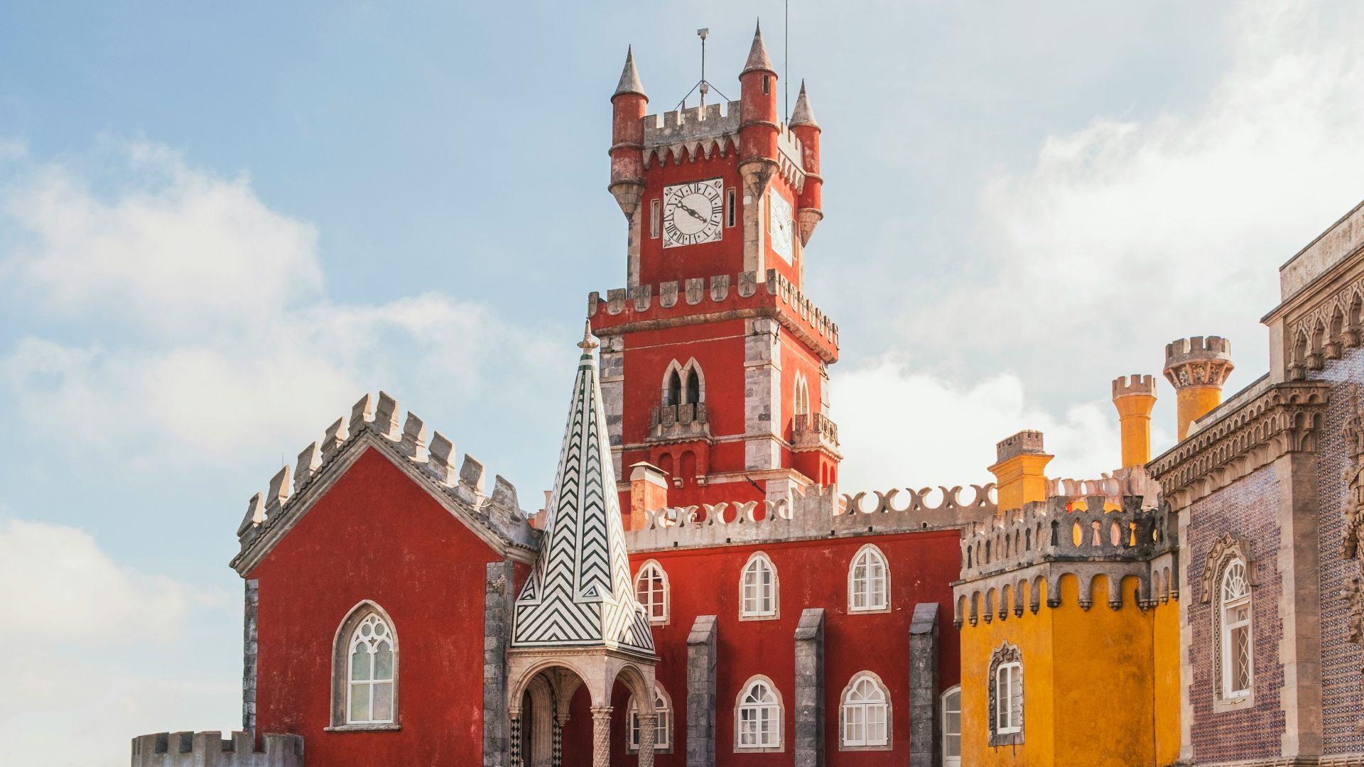 yellow and red concrete building under clear blue sky