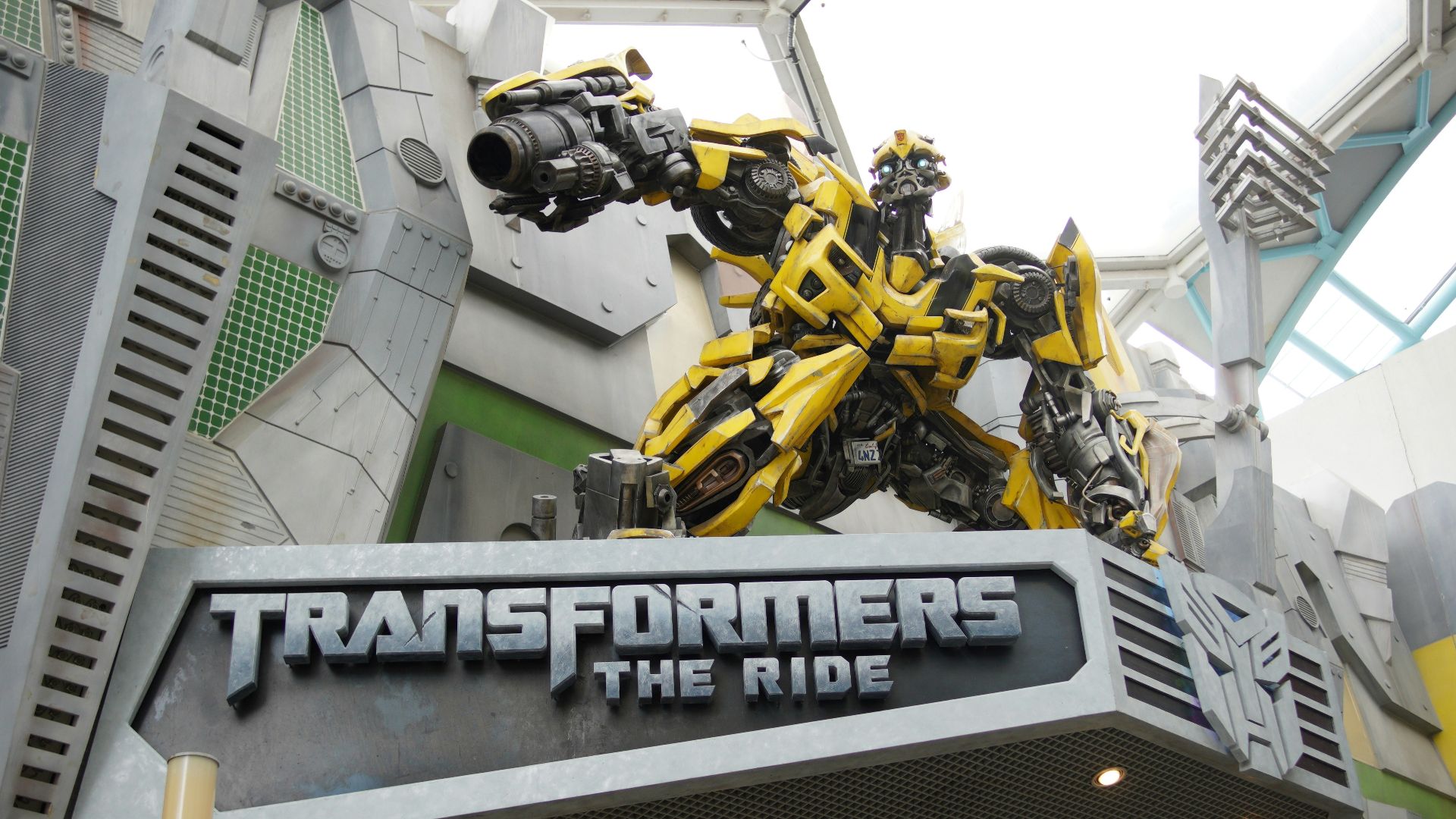 the entrance to a movie theater with a giant robot statue