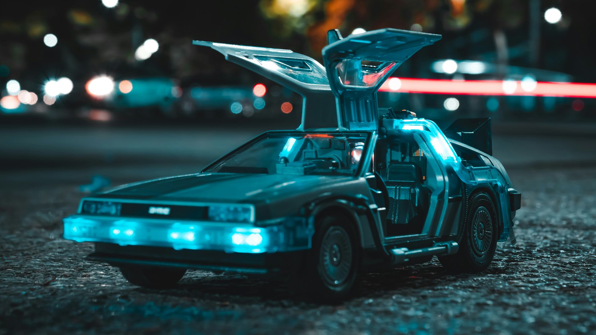 a toy car with its hood open sitting on the ground