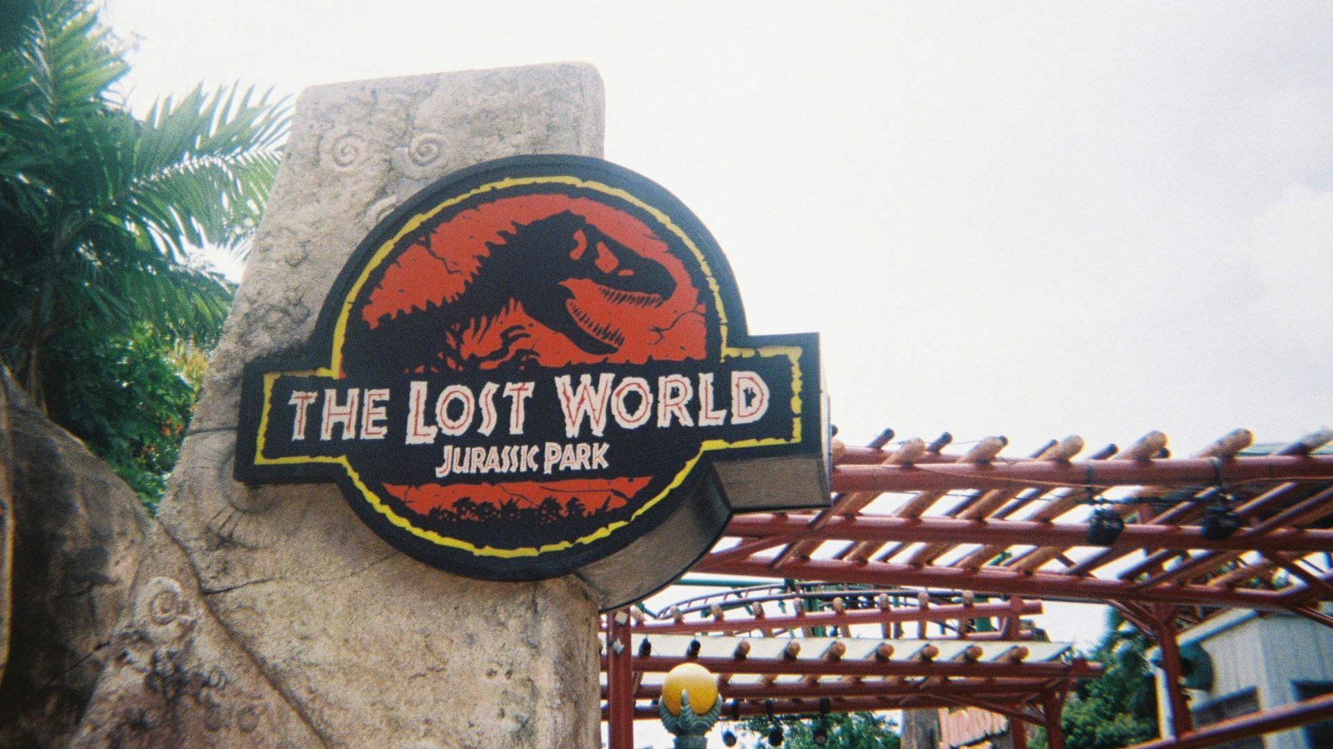 a sign for the lost world in a park