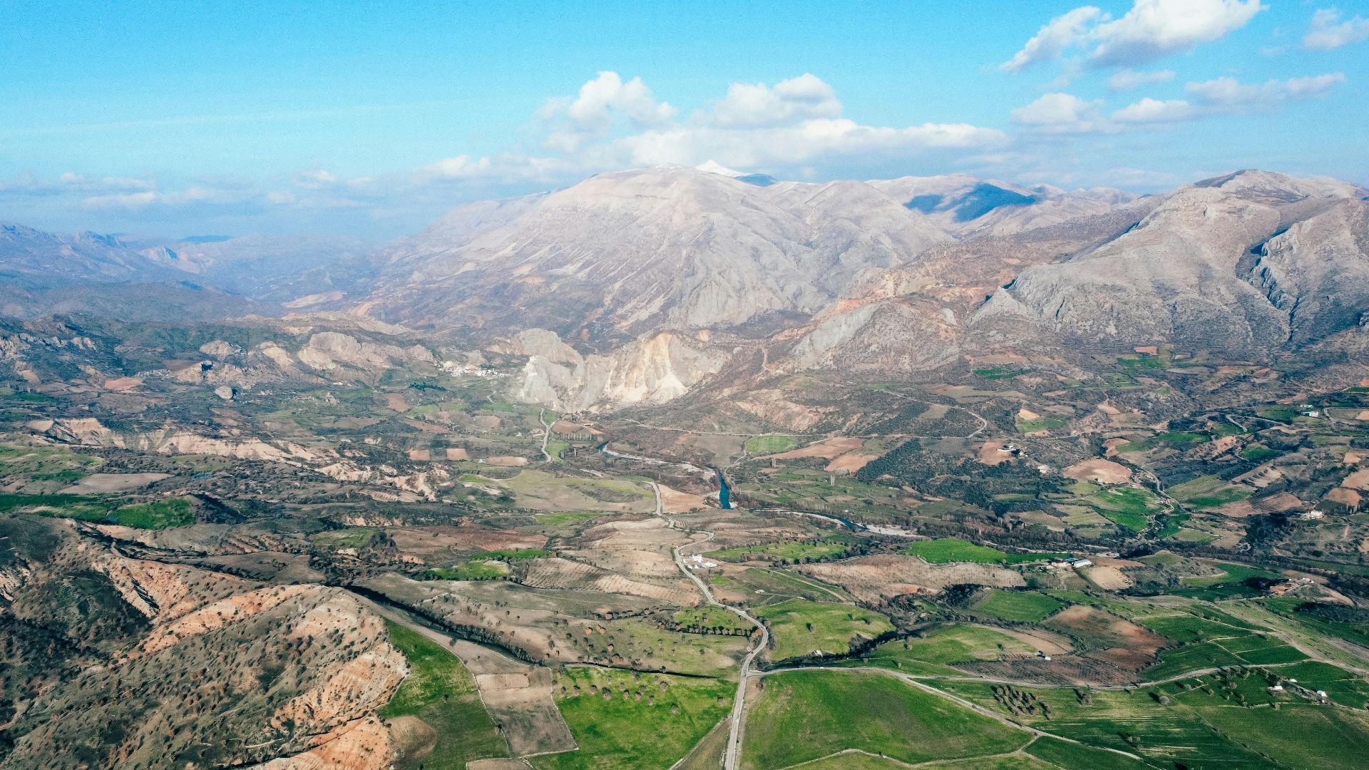 an aerial view of a valley and mountains