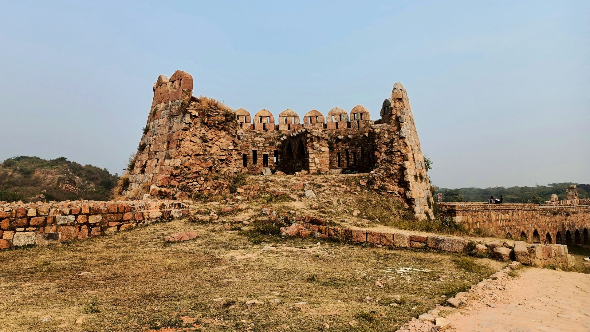a stone building with a stone wall