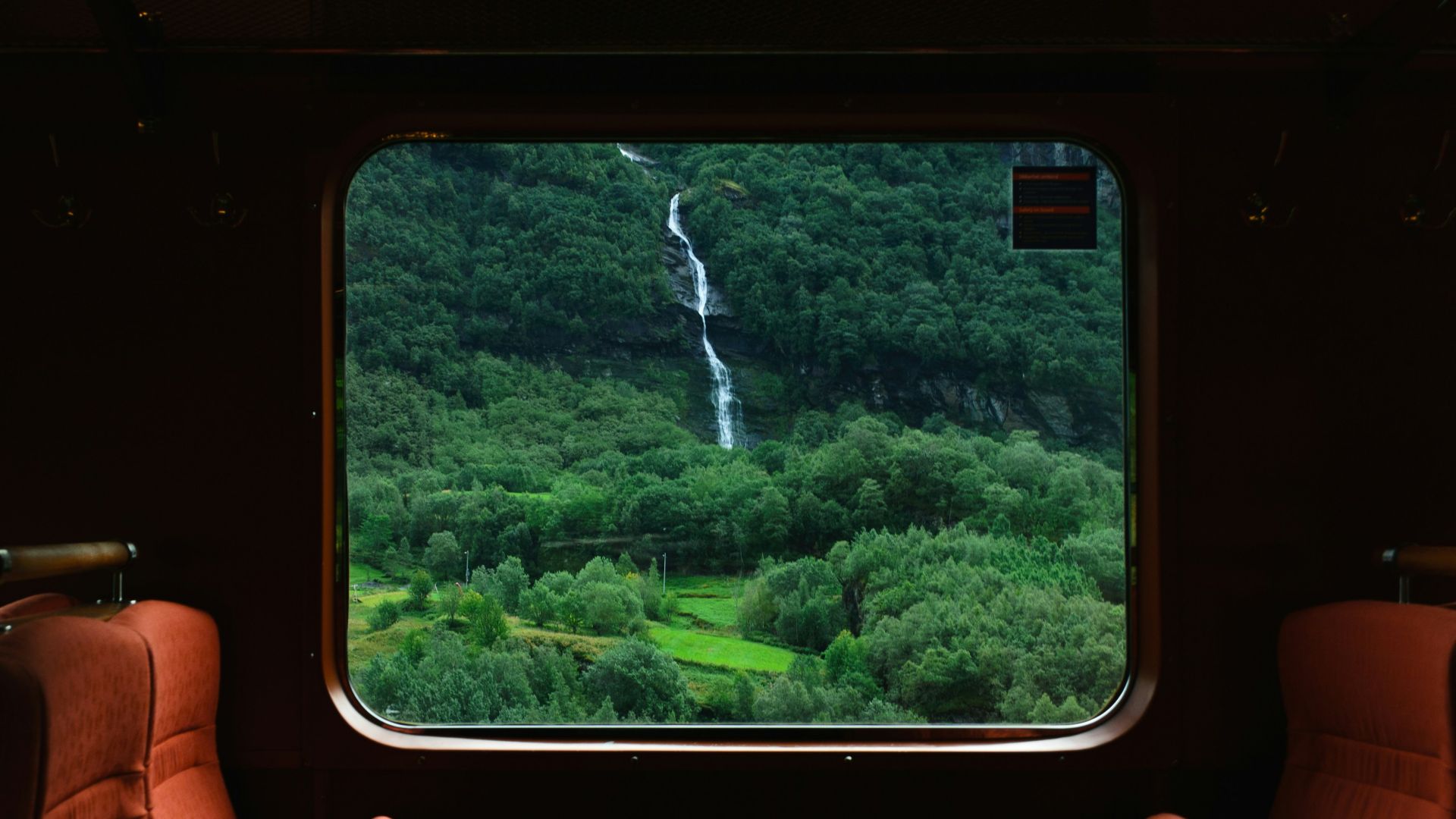 person holding black smartphone with brown leather case