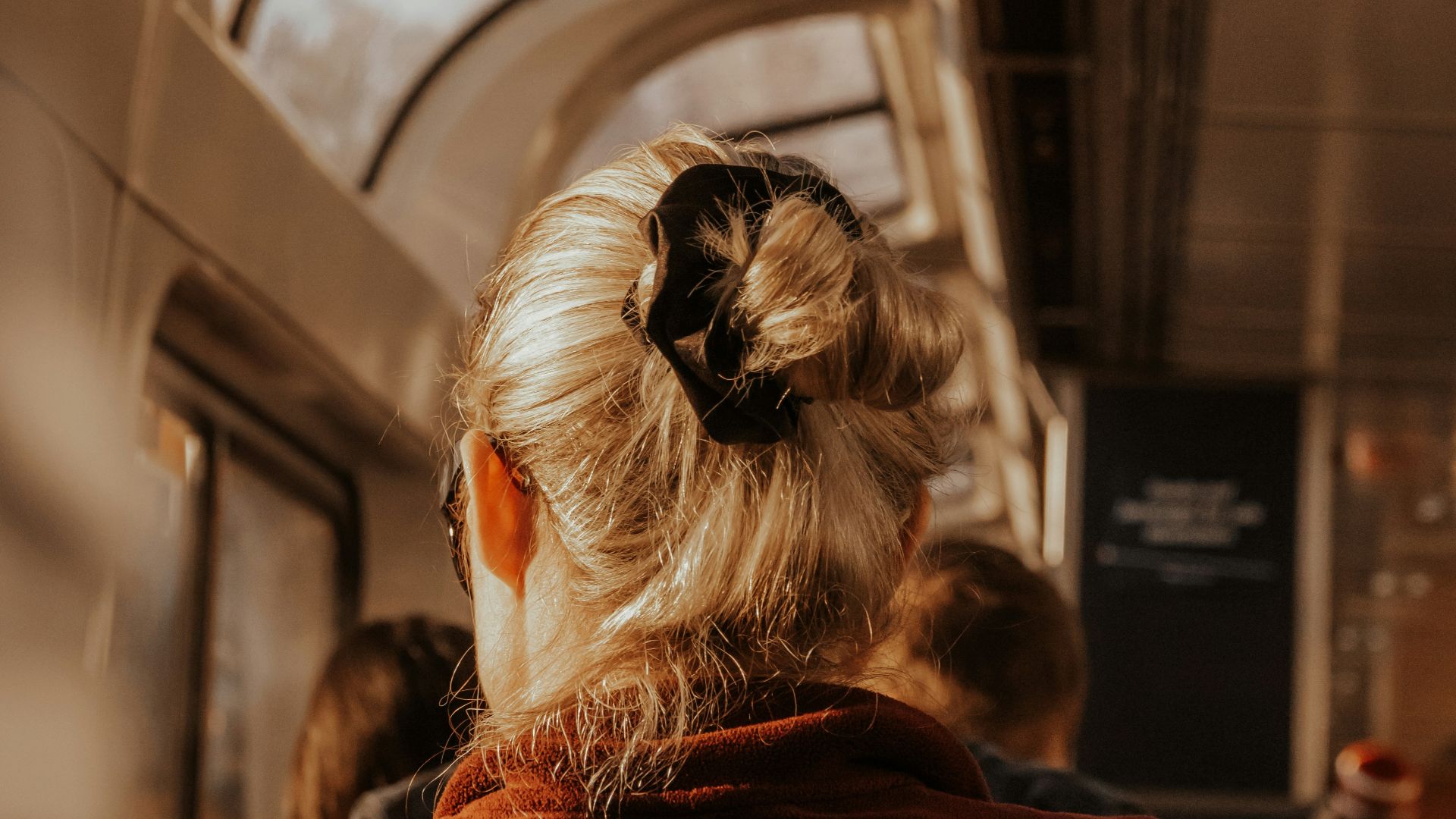 A woman sitting on a train looking out the window