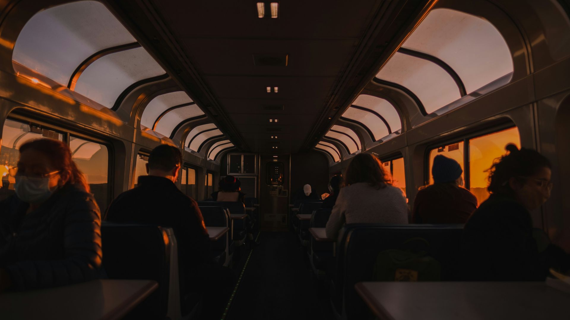 a group of people sitting on a train next to each other