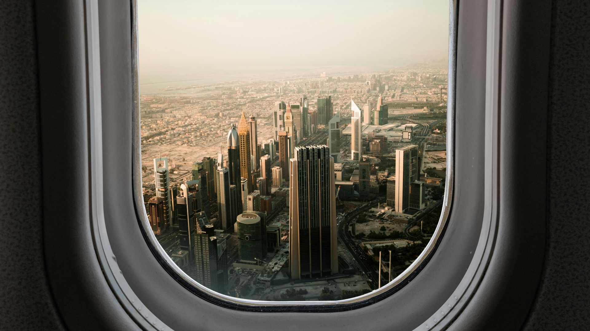 airplane window view of city during daytime