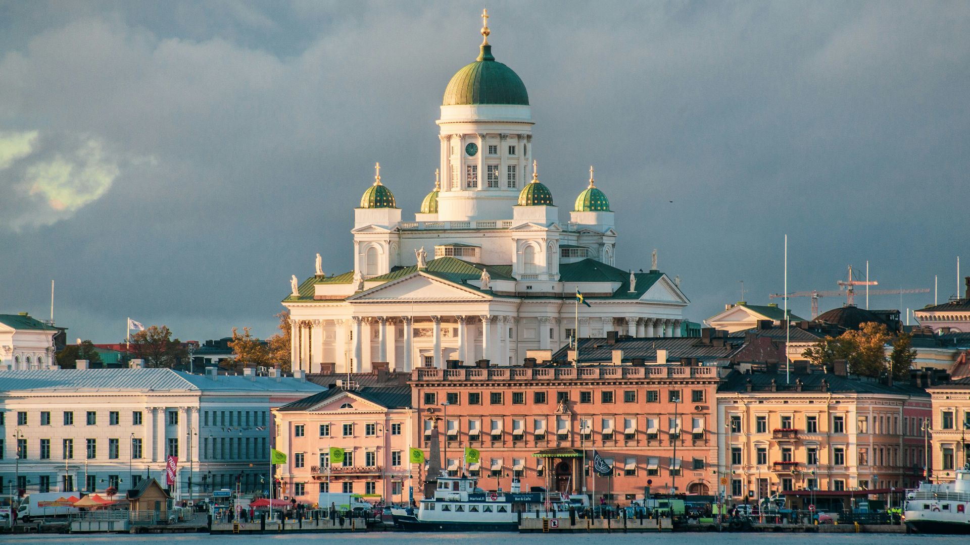 white concrete mosque near body of water