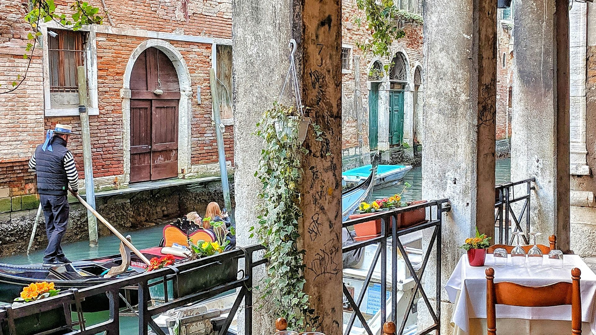 man riding on boat beside restaurant