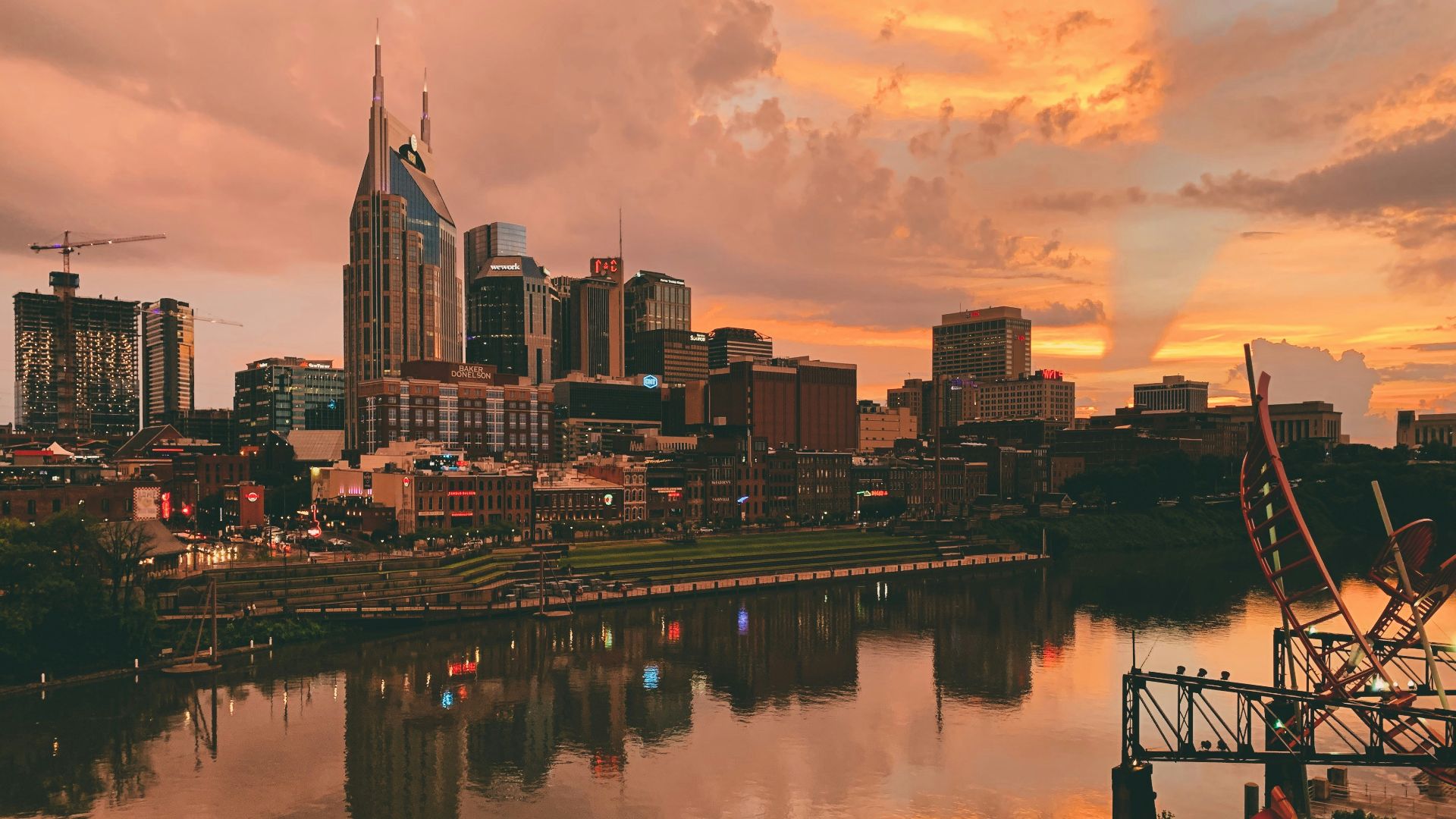 body of water near city buildings during sunset