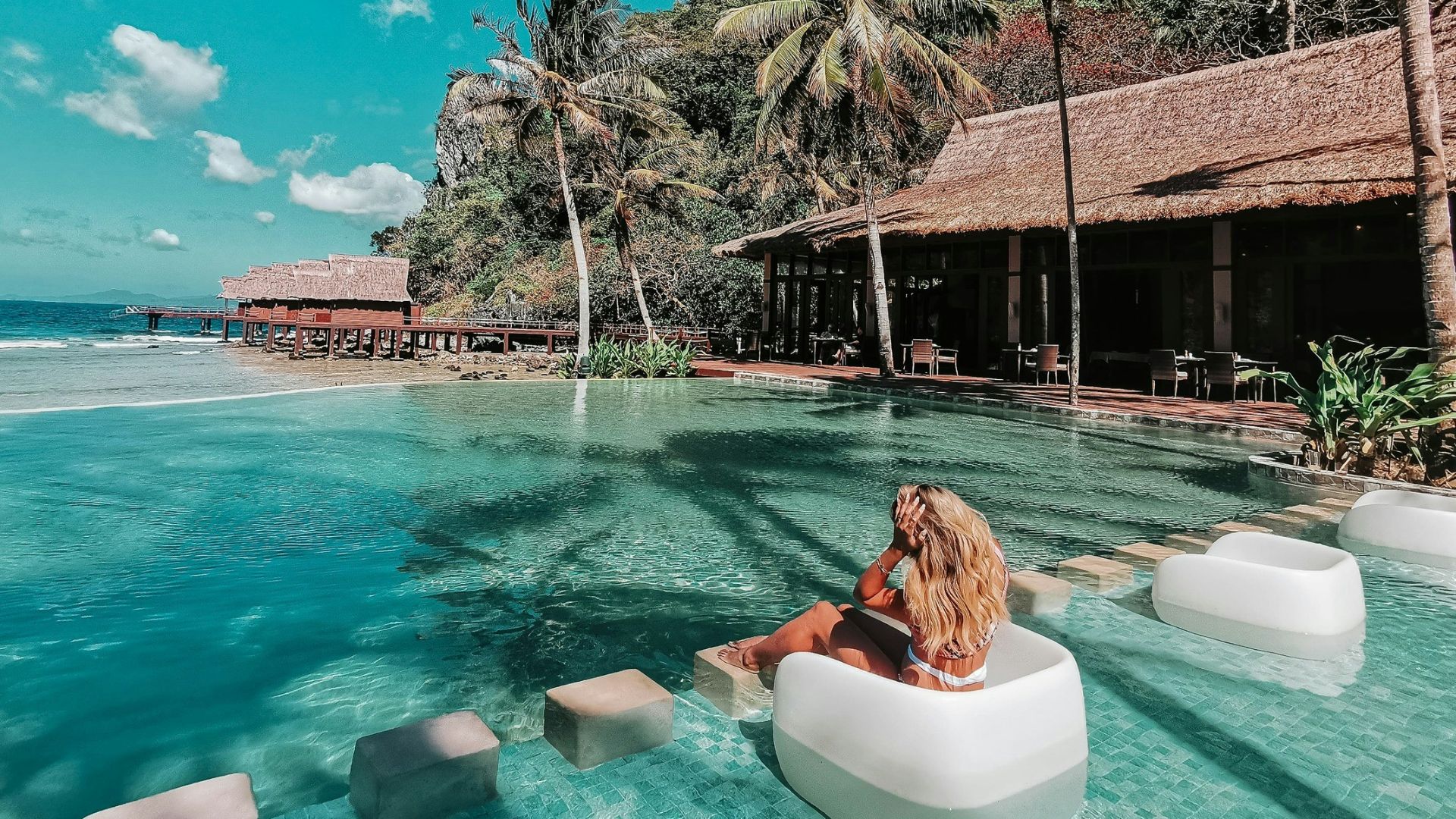 woman in swimming pool during daytime