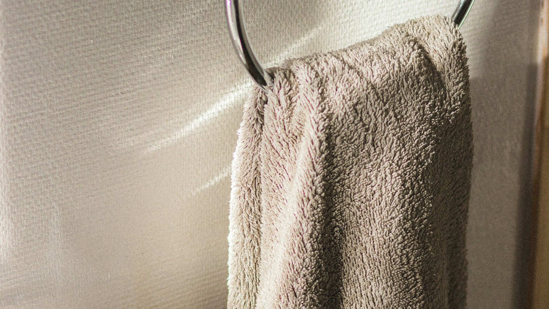 brown towel on gray metal towel rack