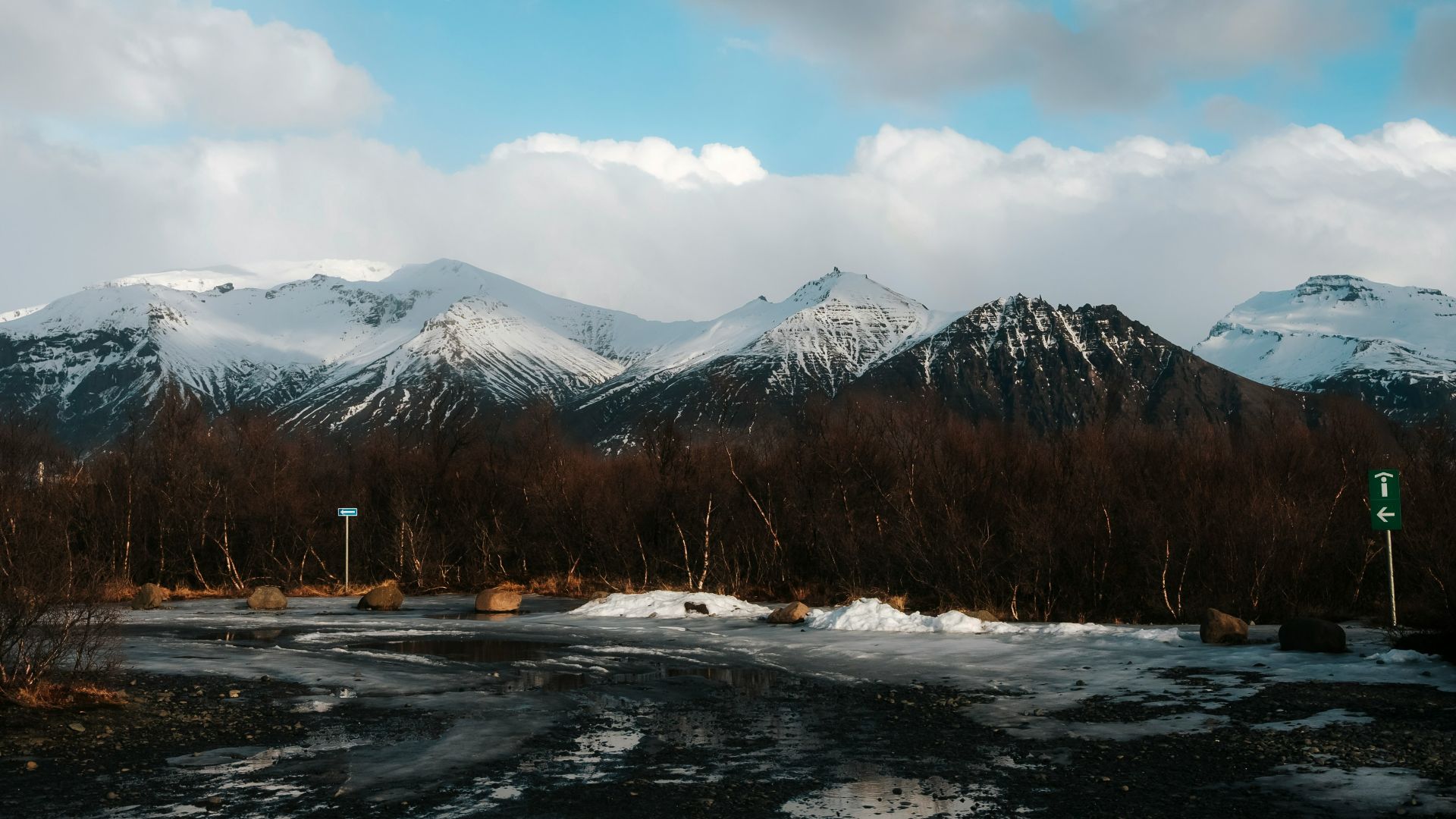 a snow covered landscape with mountains in the background