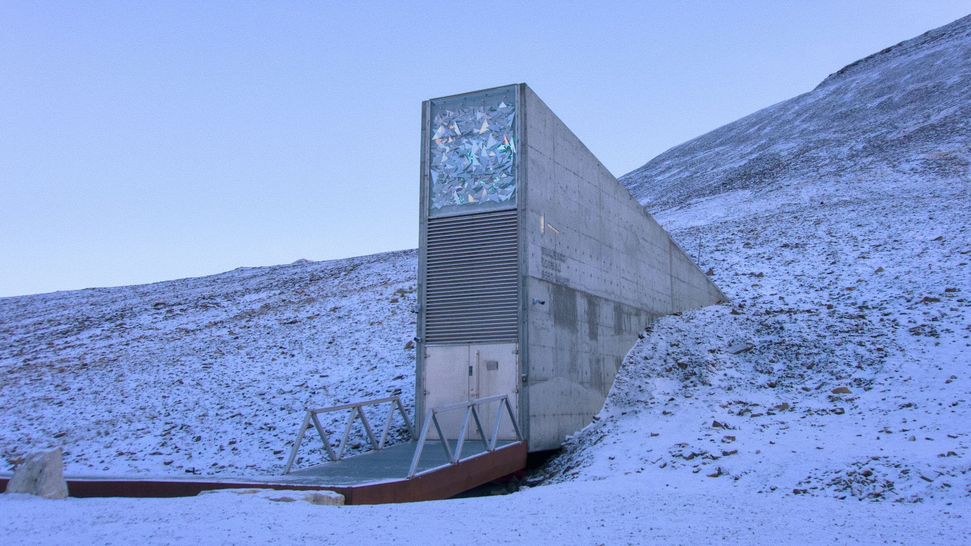 A skateboard ramp in the middle of a snowy field