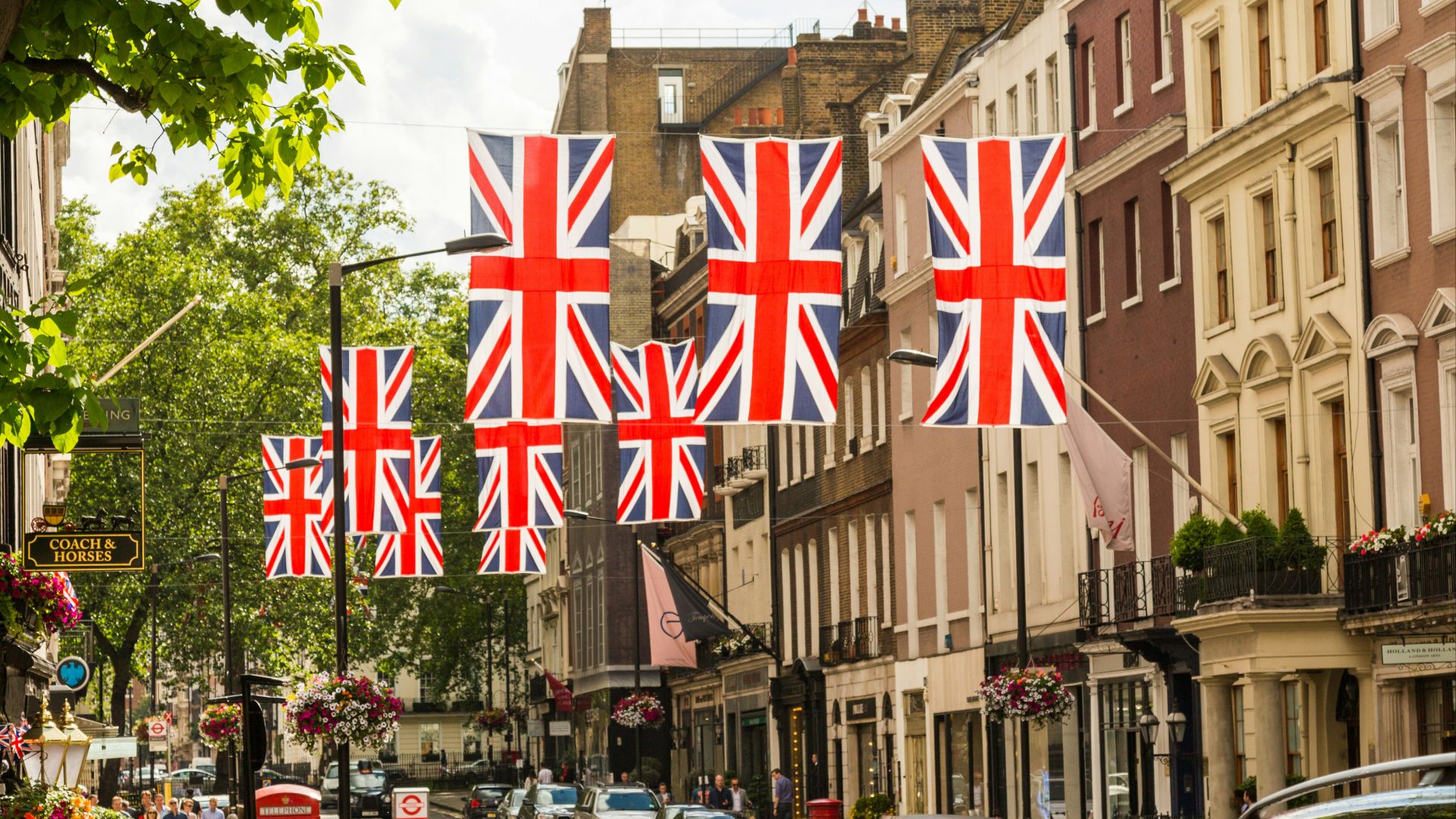 a british flag hanging over a city street