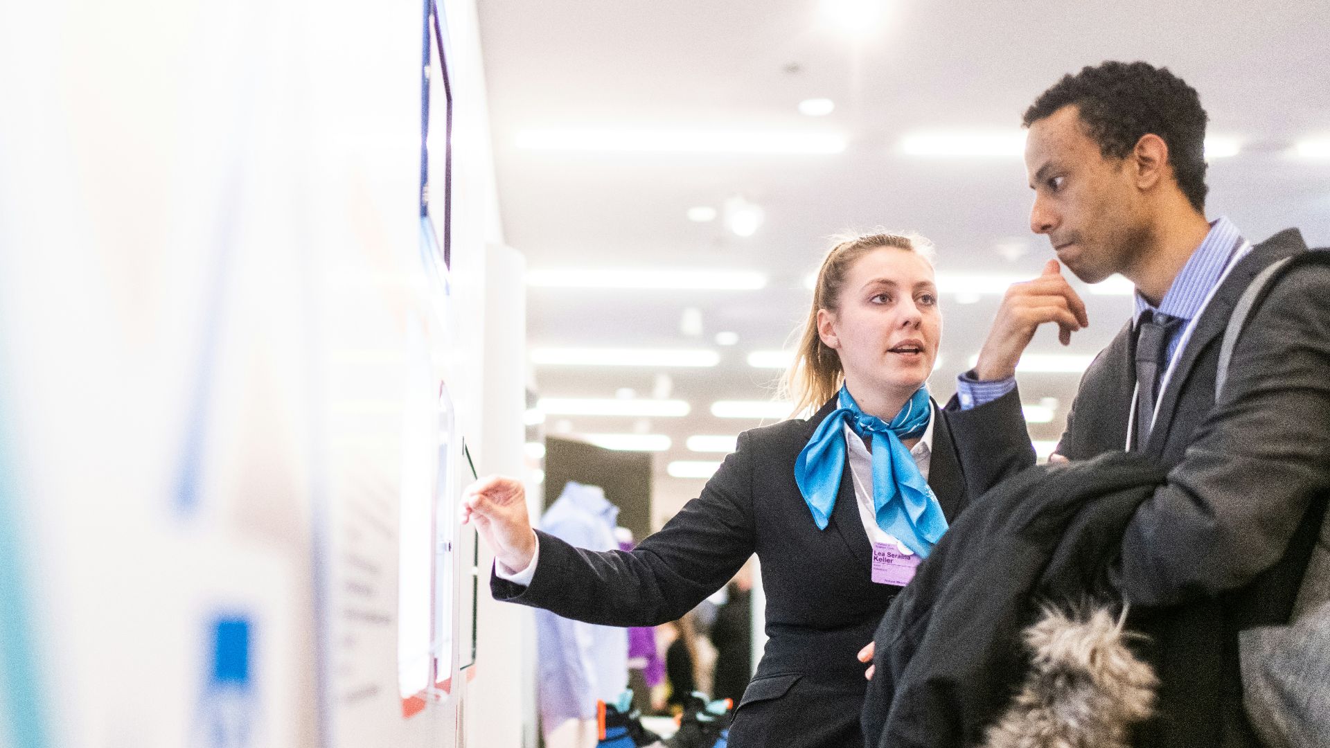 man and woman talking near the wall