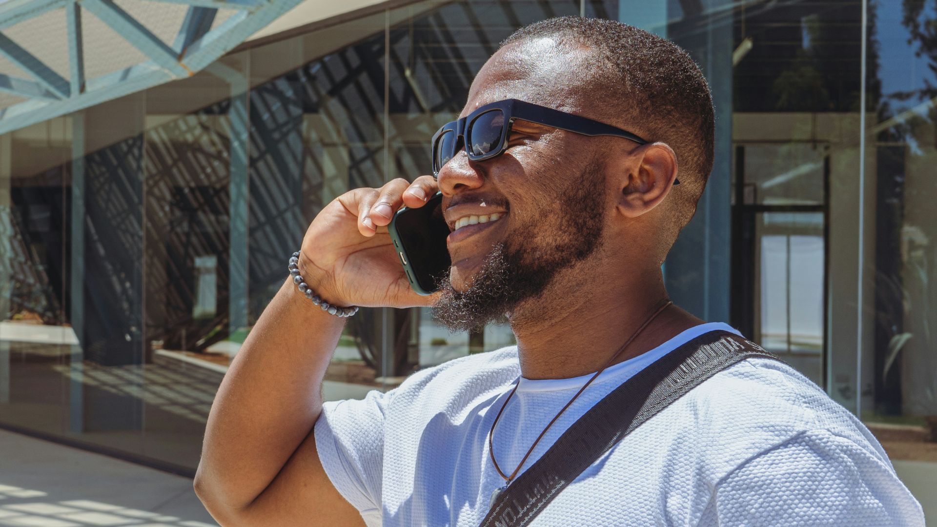 a man talking on a cell phone while wearing sunglasses