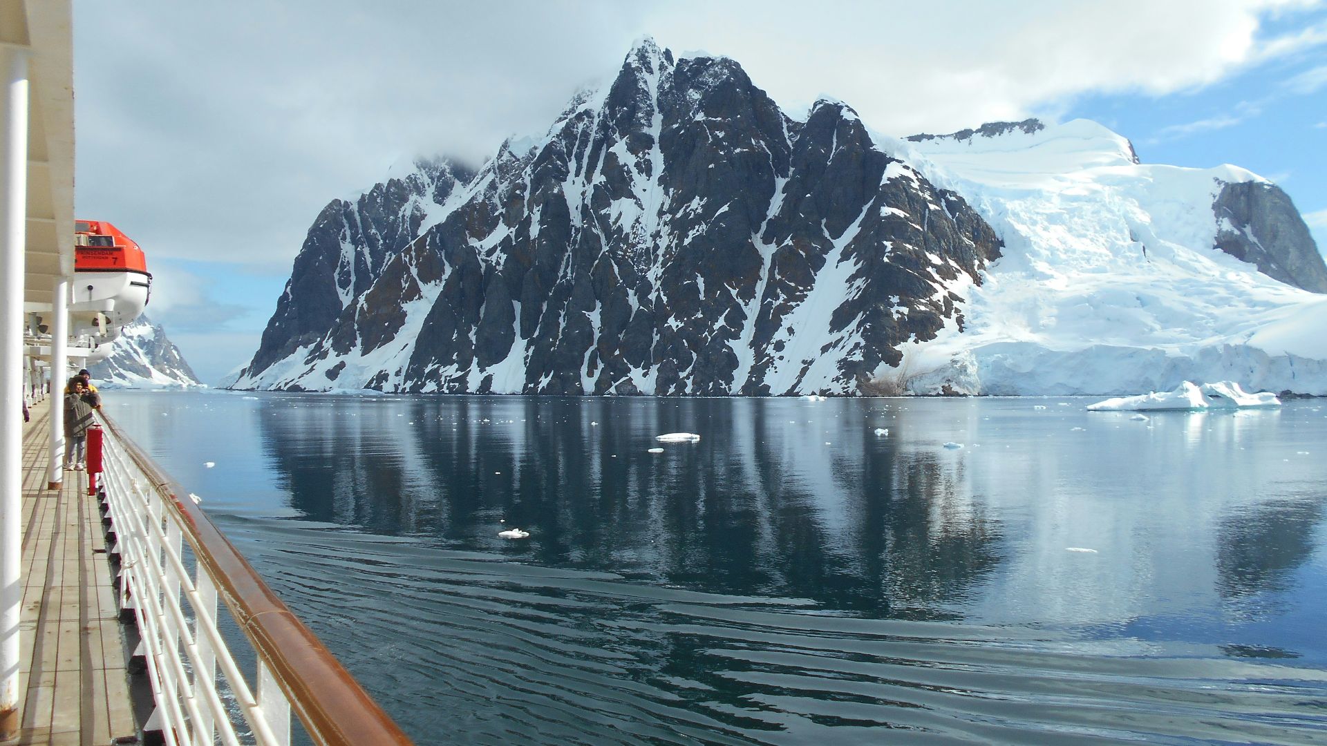 a cruise ship with a mountain in the background