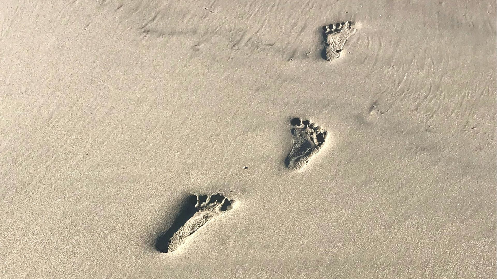 footprints on brown sand