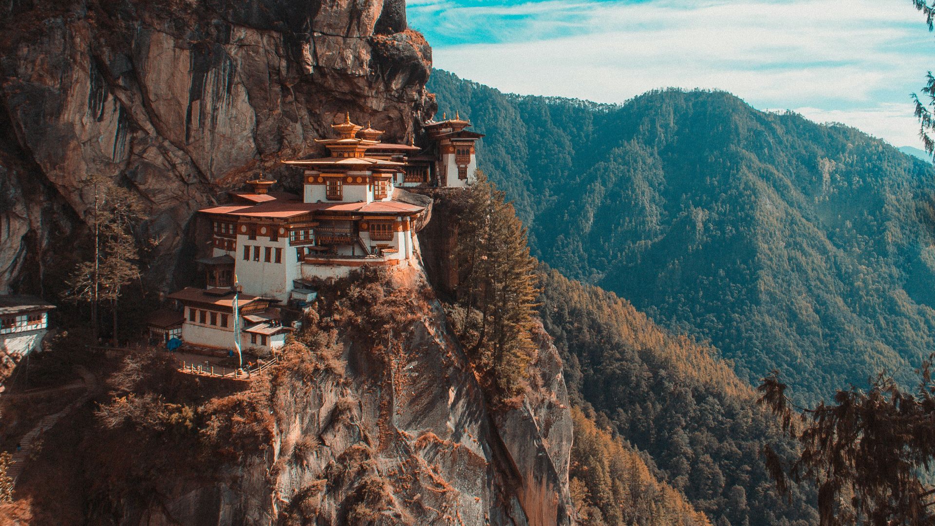 Paro Taktsang temple in Bhutan viewing mountain under blue and white sky
