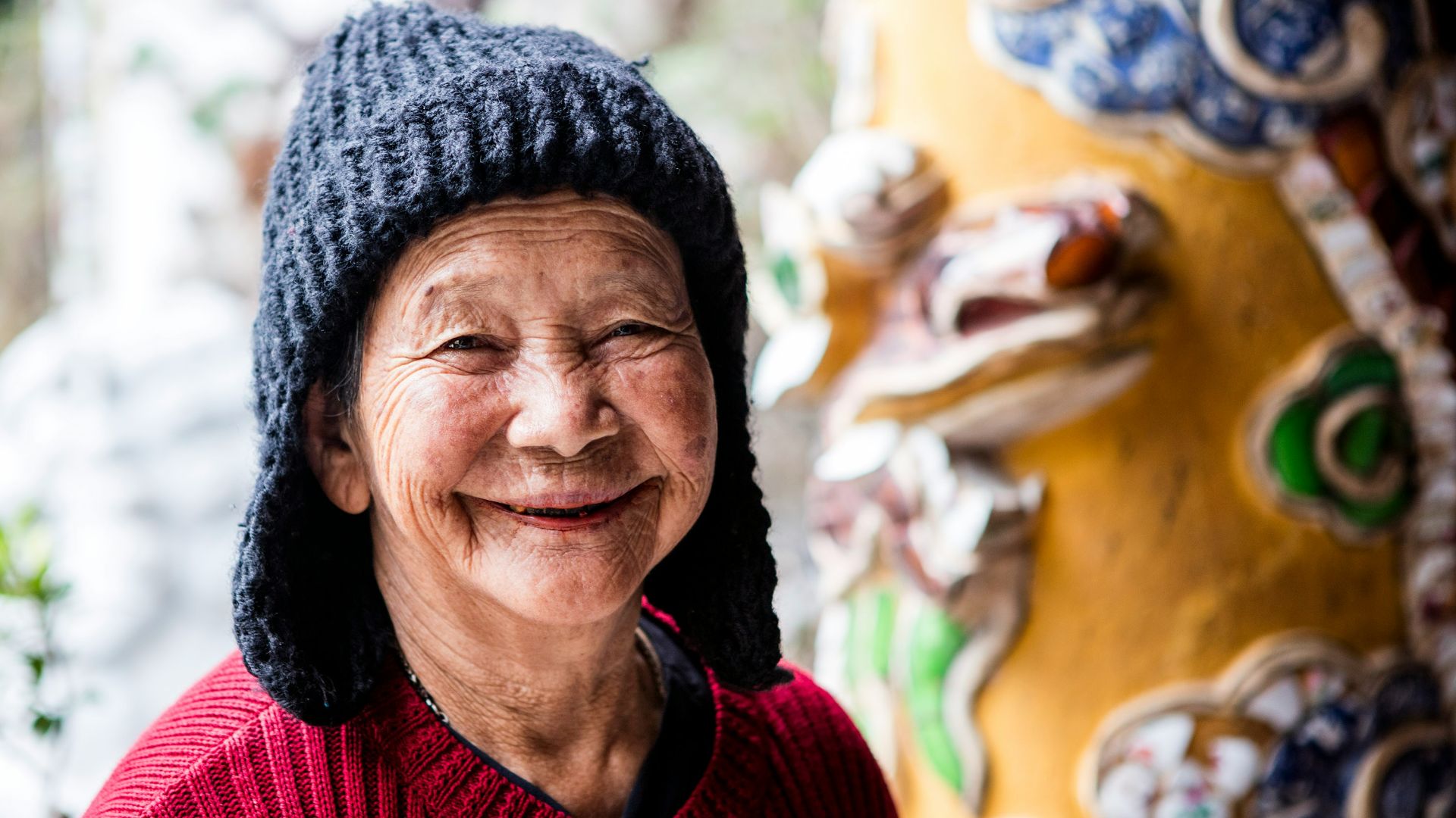 a person smiling with a hat