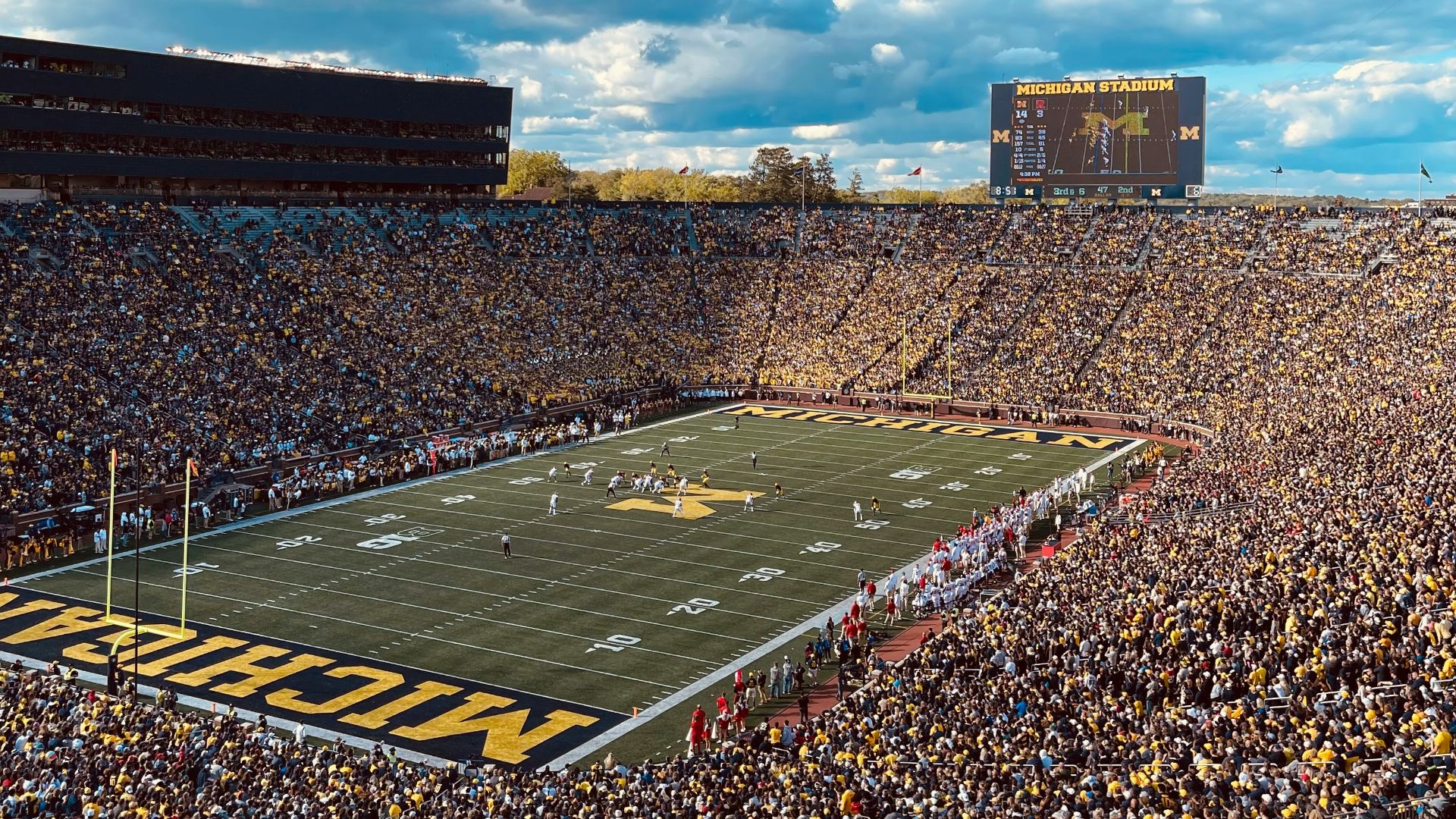 a football stadium full of fans and a football field
