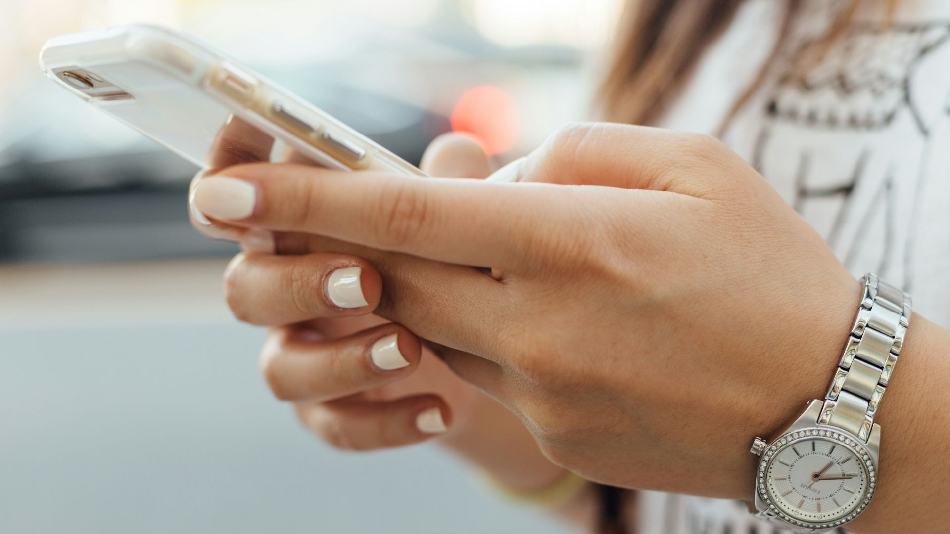 woman holding iPhone during daytime