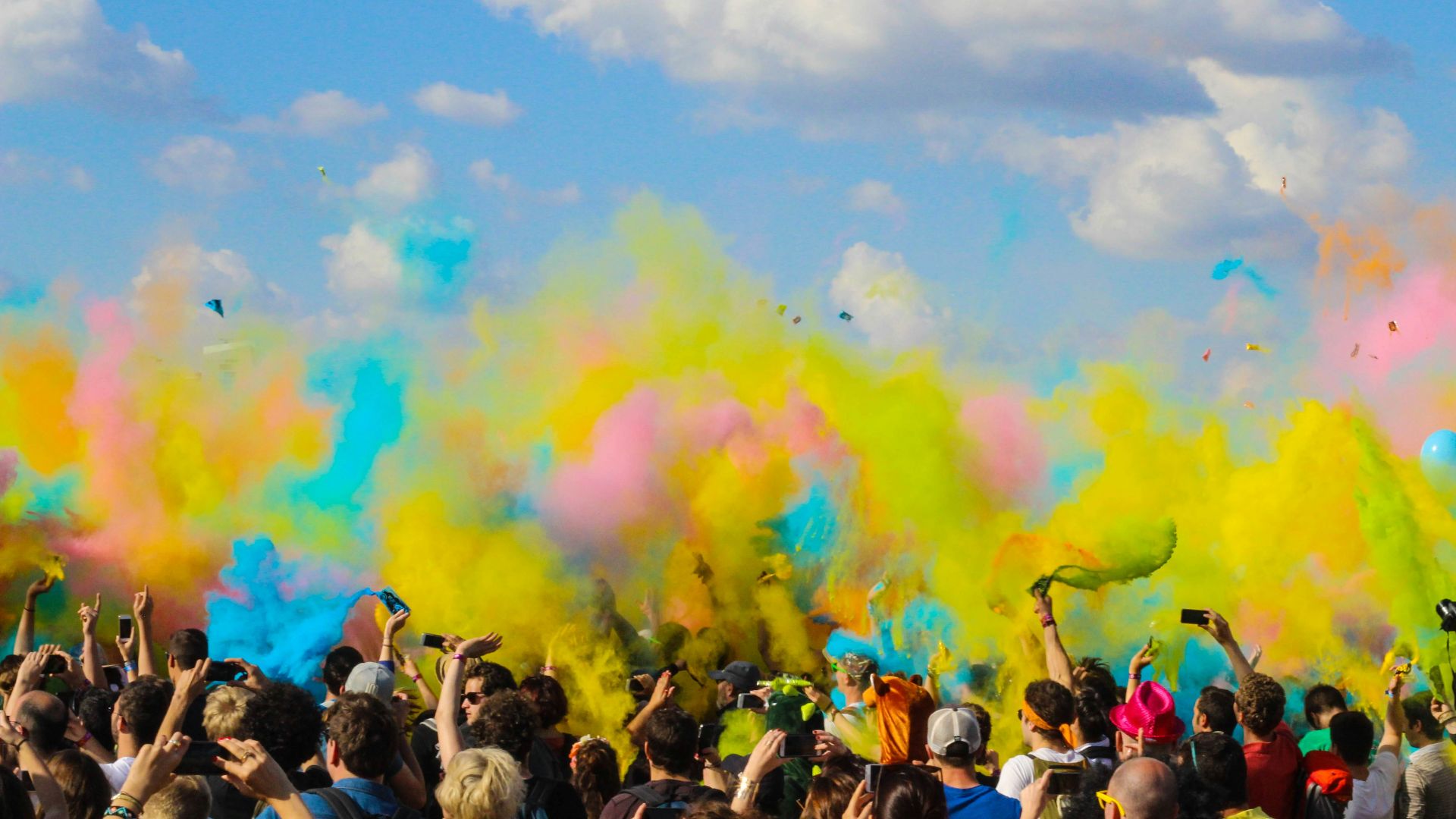 group of people celebrating powder festival outdoors