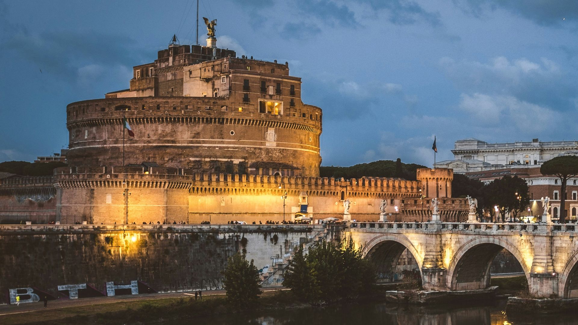 gray concrete bridge and brown concrete building under blue sky