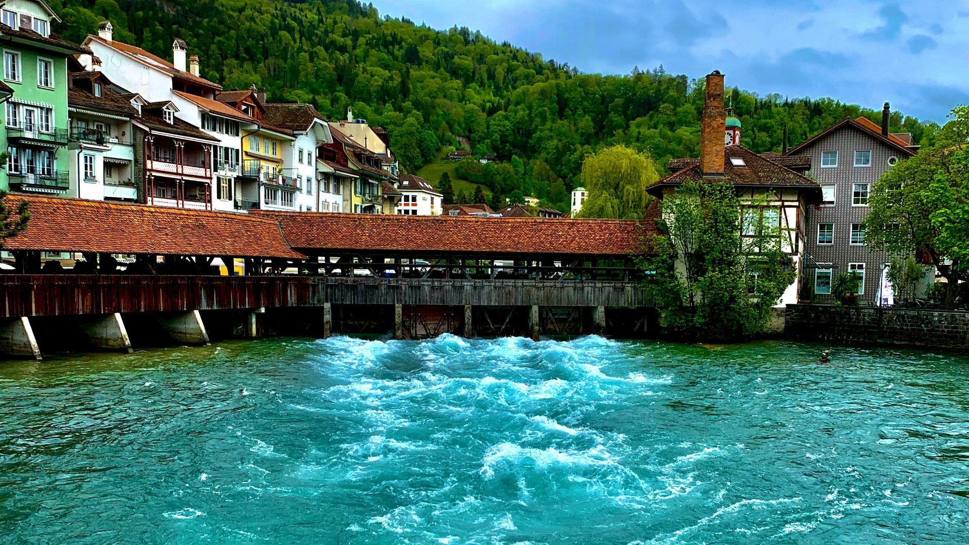 a body of water with houses in the background
